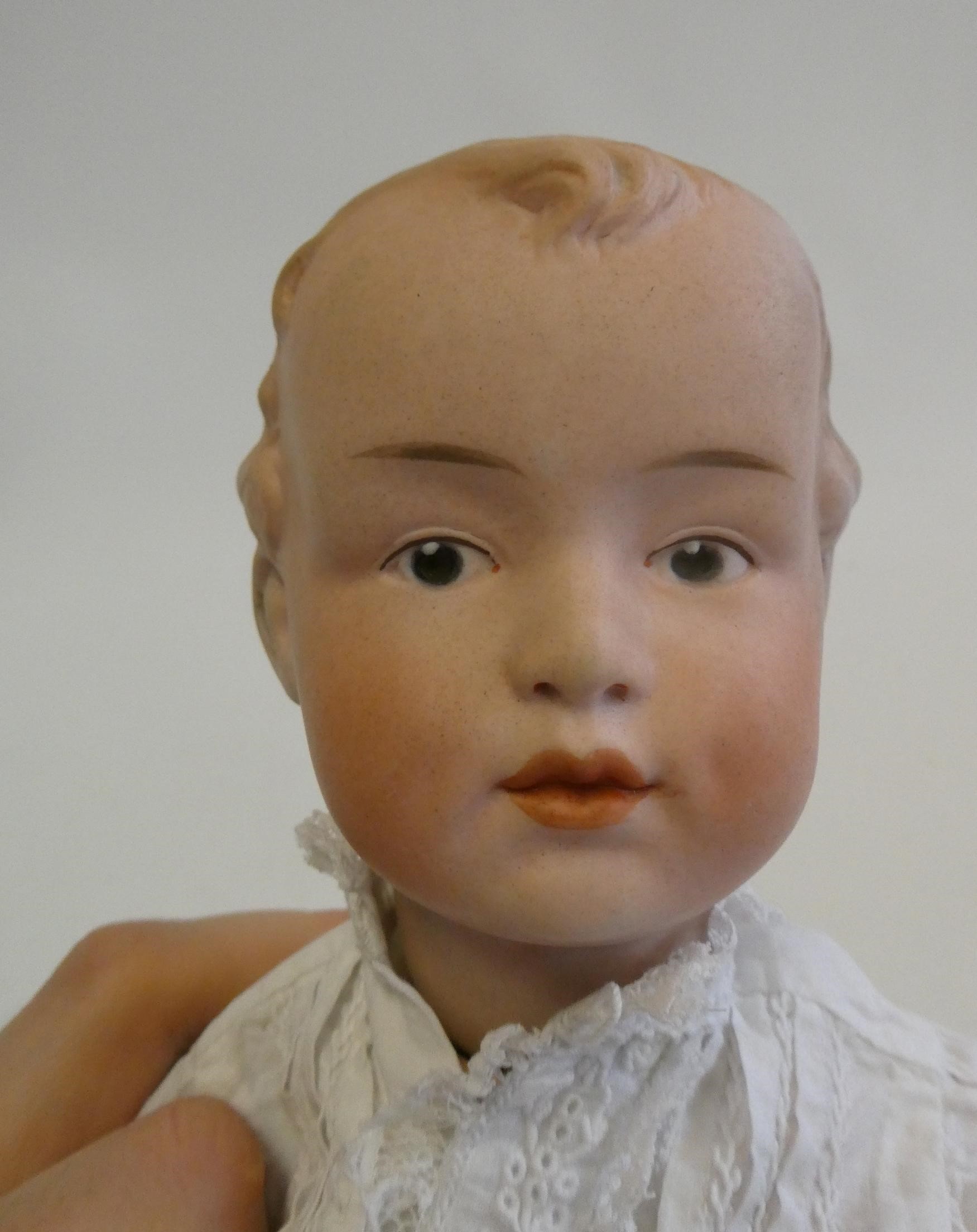 A Gebruder Heubach bisque socket head boy doll, with moulded eyes, moulded hair, closed mouth, wood Image