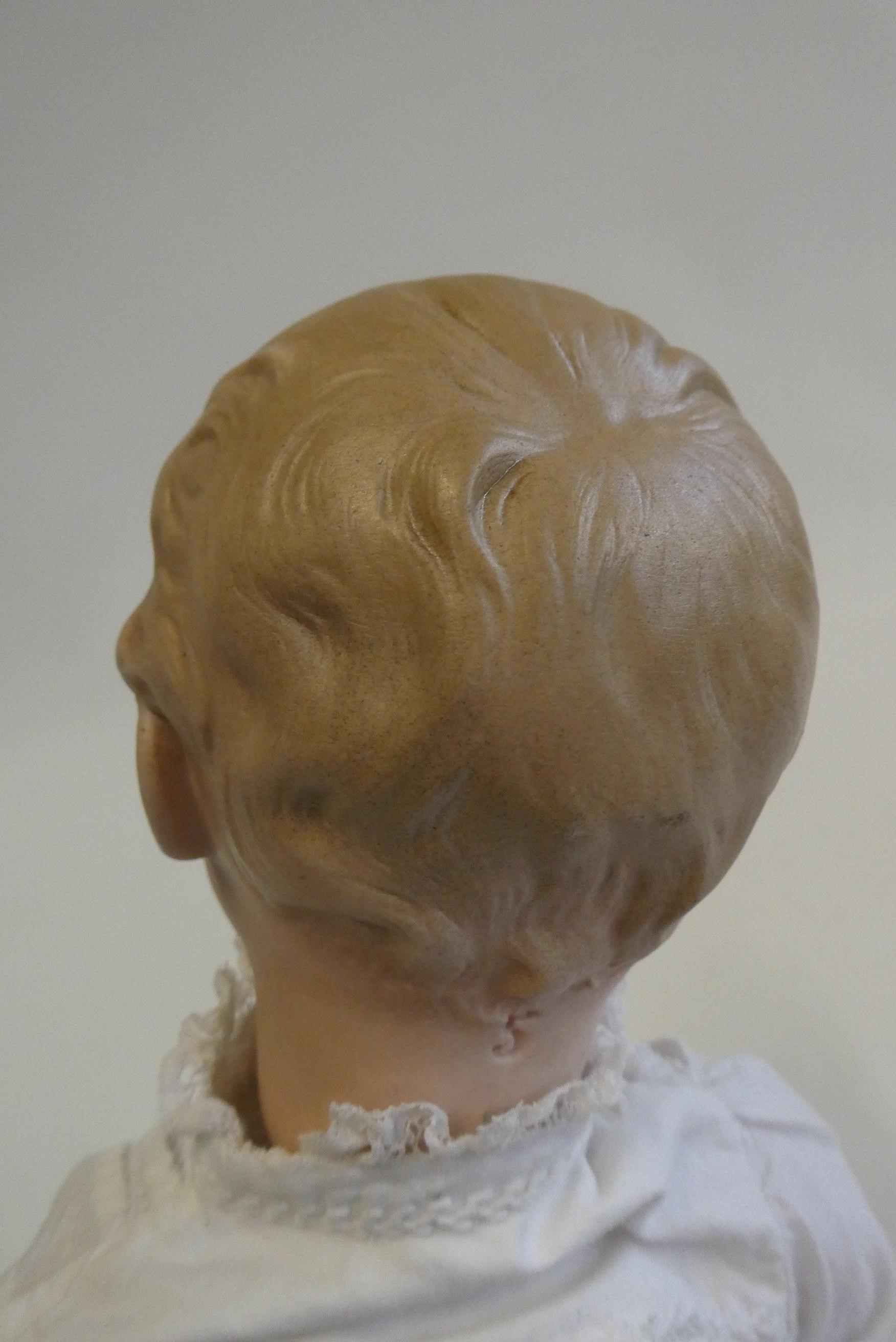 A Gebruder Heubach bisque socket head boy doll, with moulded eyes, moulded hair, closed mouth, wood Image