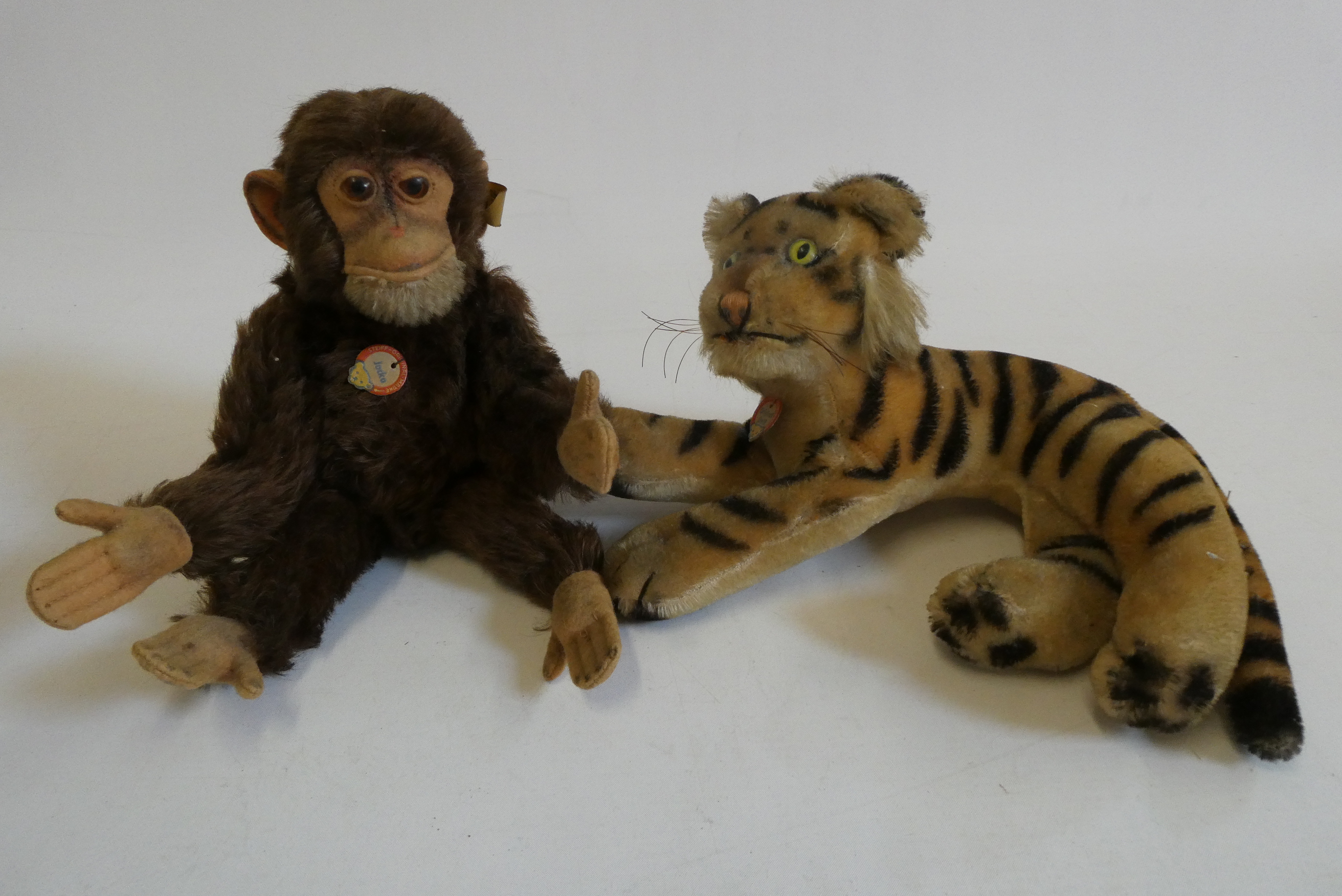 Two vintage Steiff animals, comprising a Jocko monkey and a tiger, both with card labels, Jocko with Image