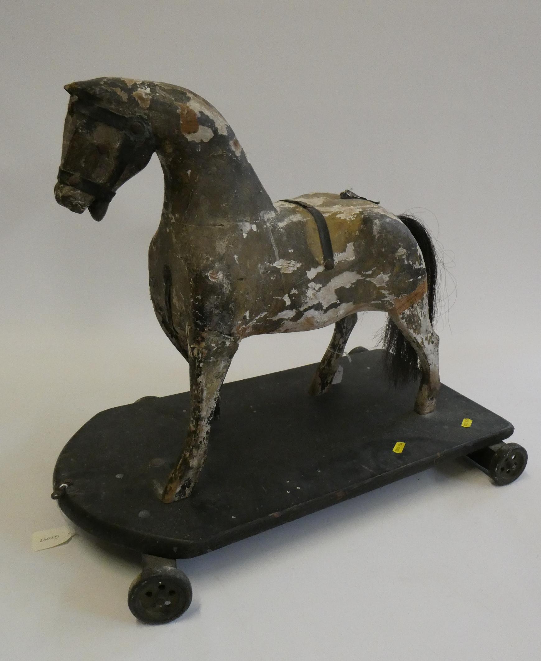 An antique carved wood pull-a-long horse, with horse hair tail, wooden base and metal wheels, 23 Image