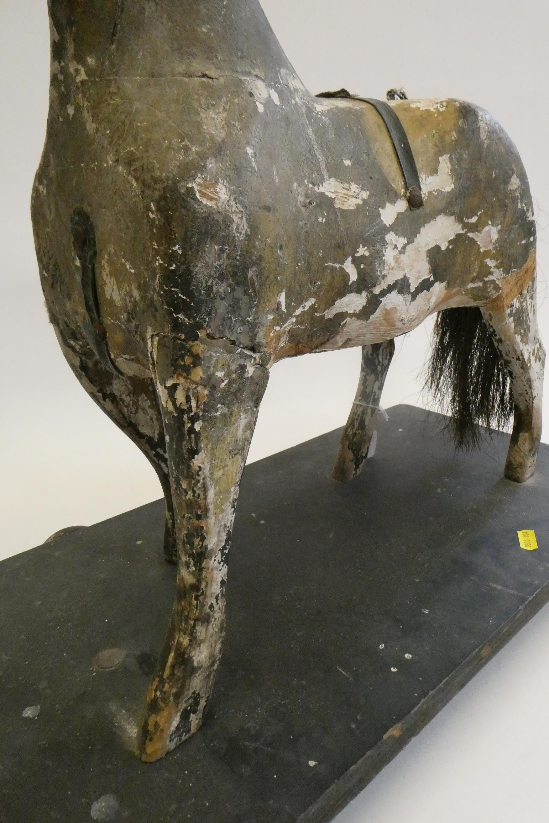 An antique carved wood pull-a-long horse, with horse hair tail, wooden base and metal wheels, 23 Image