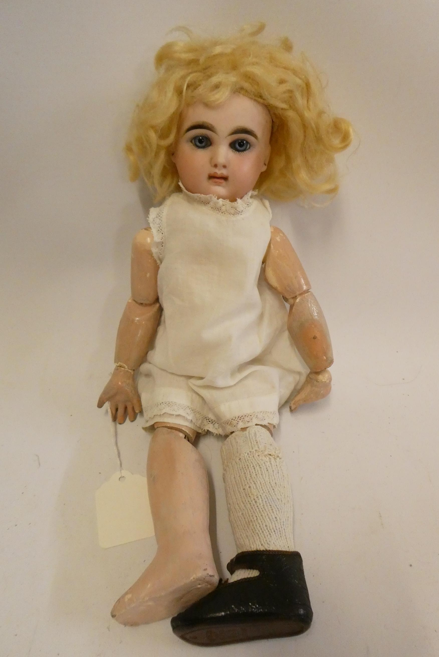 A French bisque socket head girl doll, with blue glass fixed eyes, moulded closed mouth, pierced Image