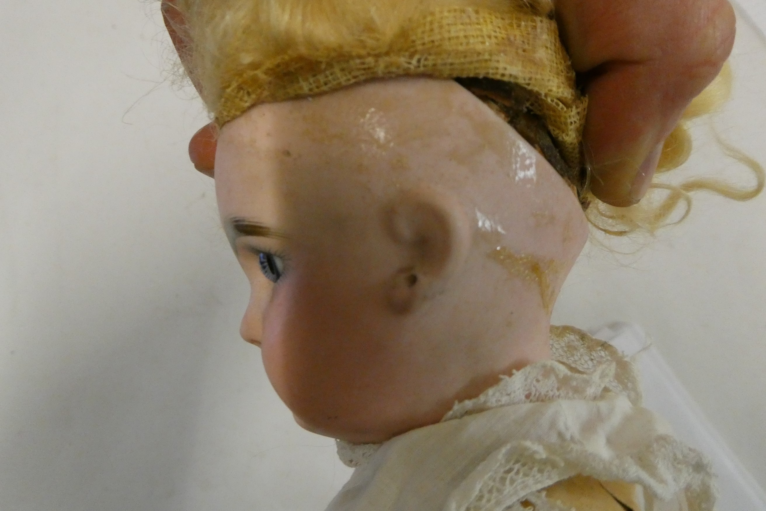 A French bisque socket head girl doll, with blue glass fixed eyes, moulded closed mouth, pierced Image