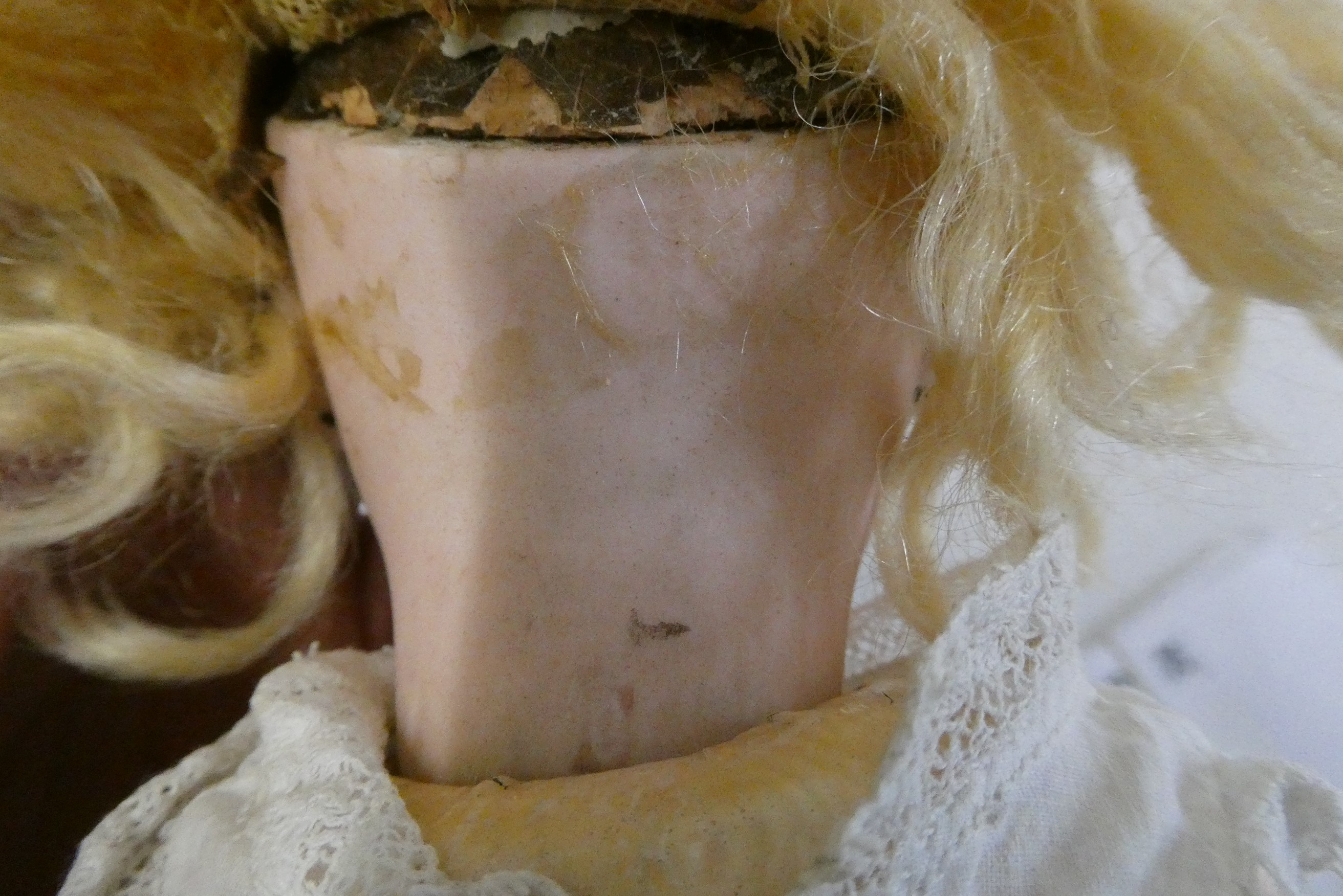 A French bisque socket head girl doll, with blue glass fixed eyes, moulded closed mouth, pierced Image