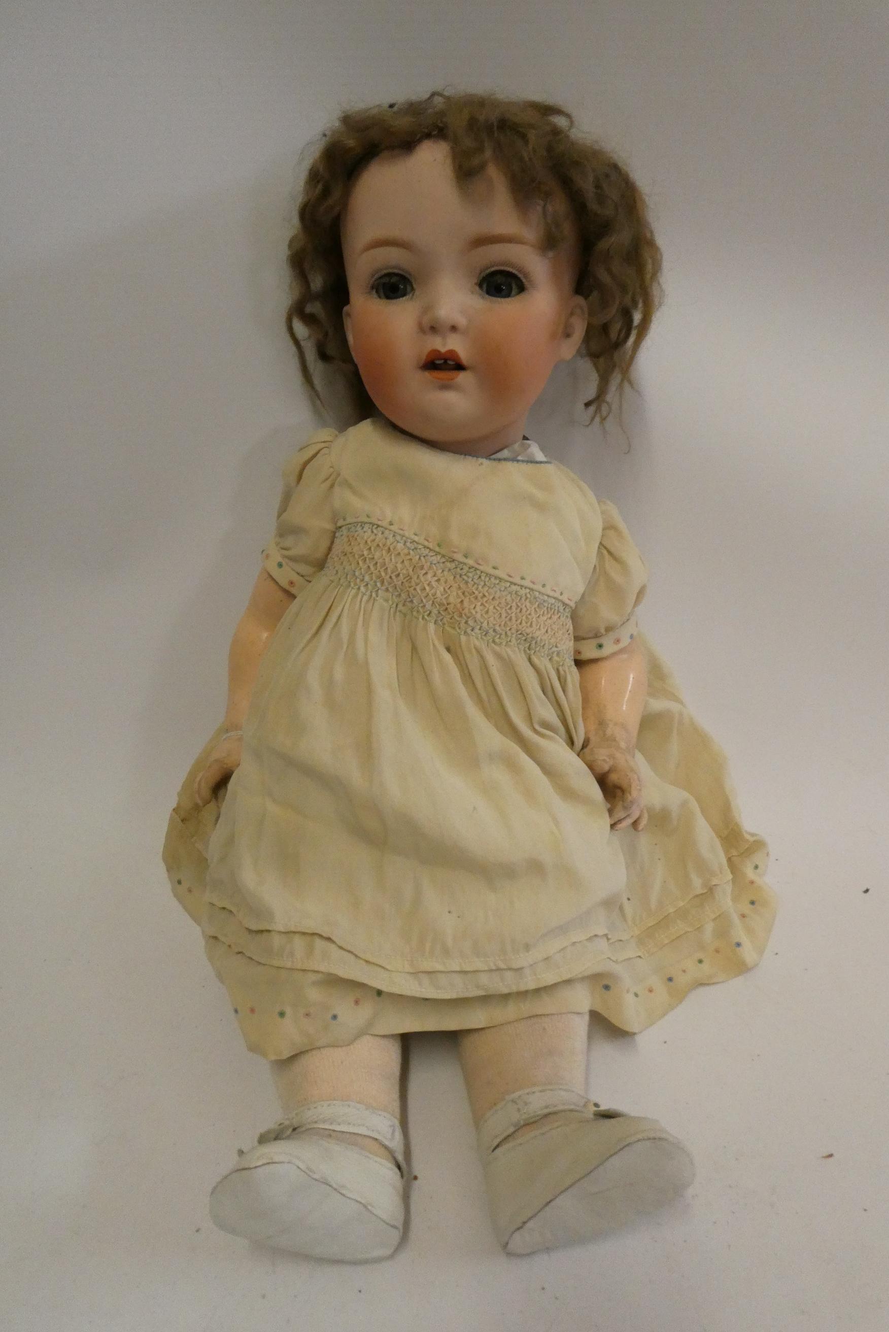 A Heubach bisque socket head doll, with blue glass sleeping eyes, open mouth, teeth, tongue, bent Image