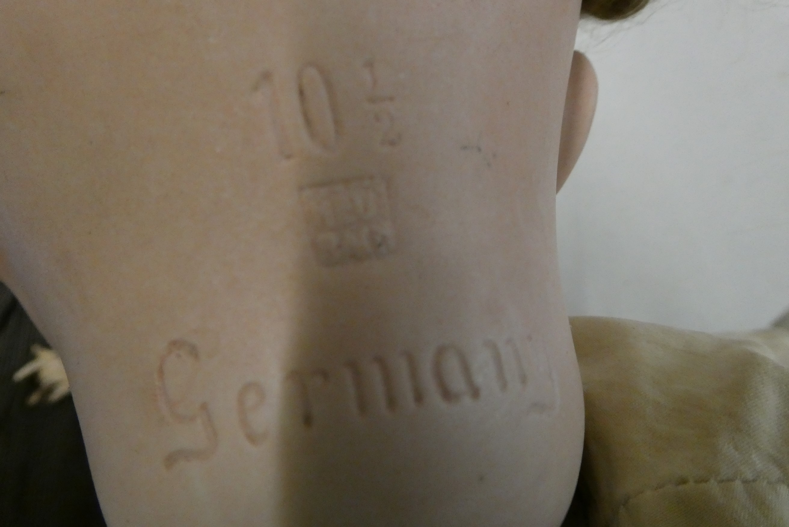 A Heubach bisque socket head doll, with blue glass sleeping eyes, open mouth, teeth, tongue, bent Image