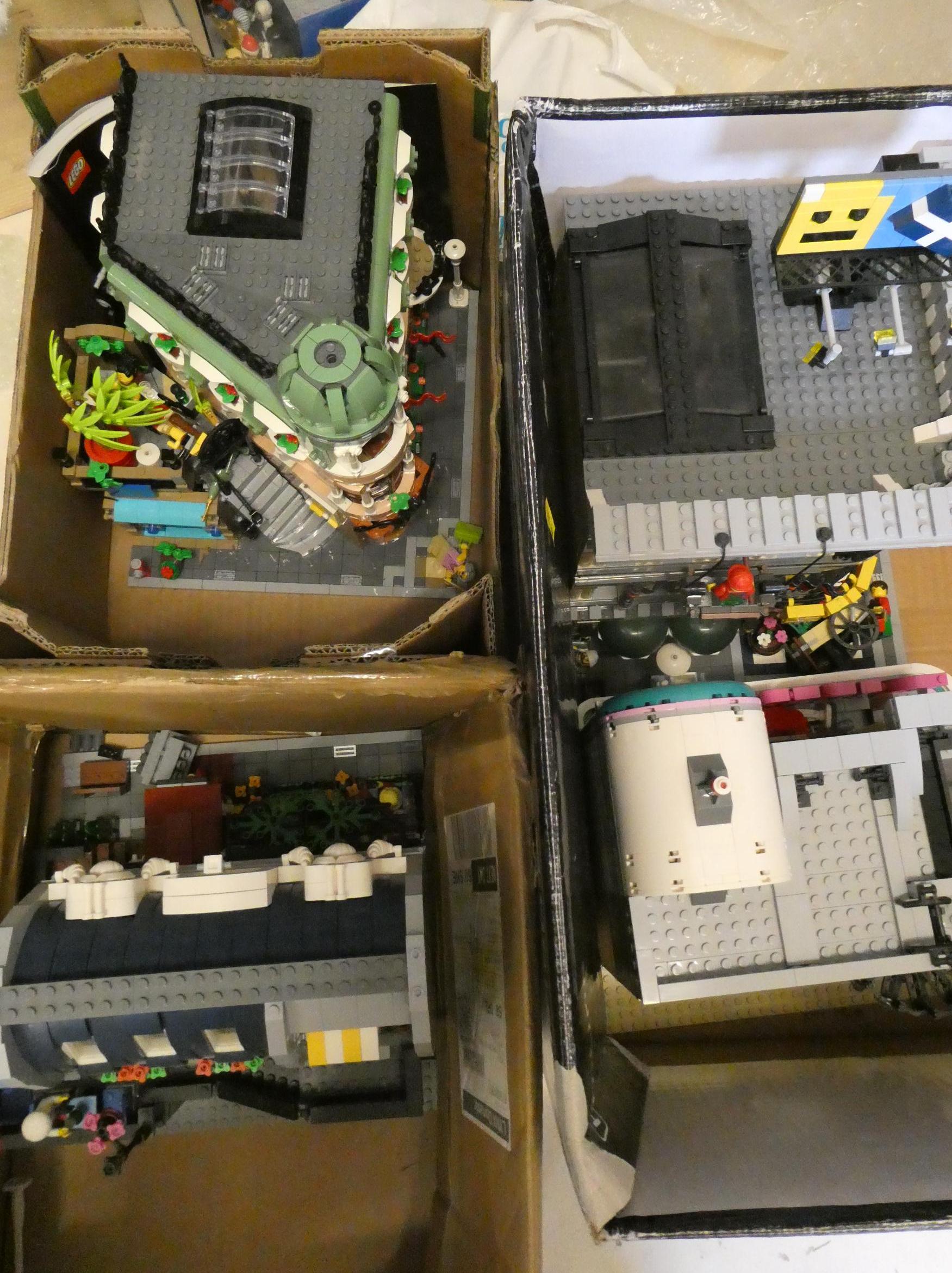 Three boxes of built Lego buildings, unchecked for completeness Image
