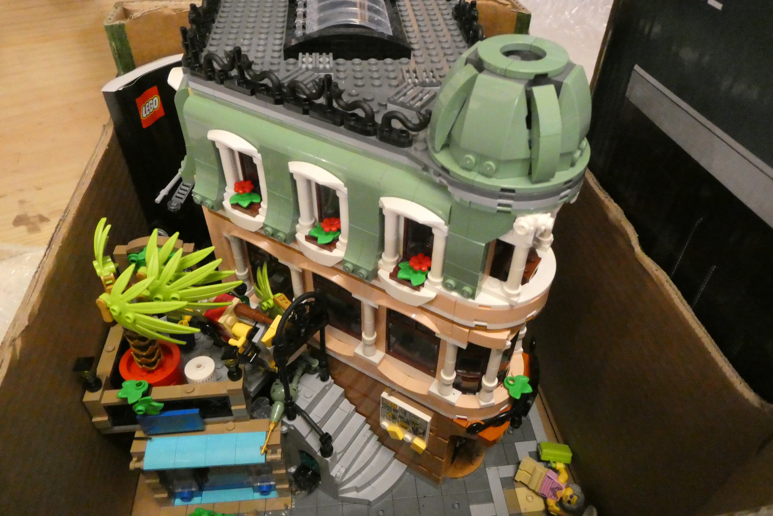 Three boxes of built Lego buildings, unchecked for completeness Image