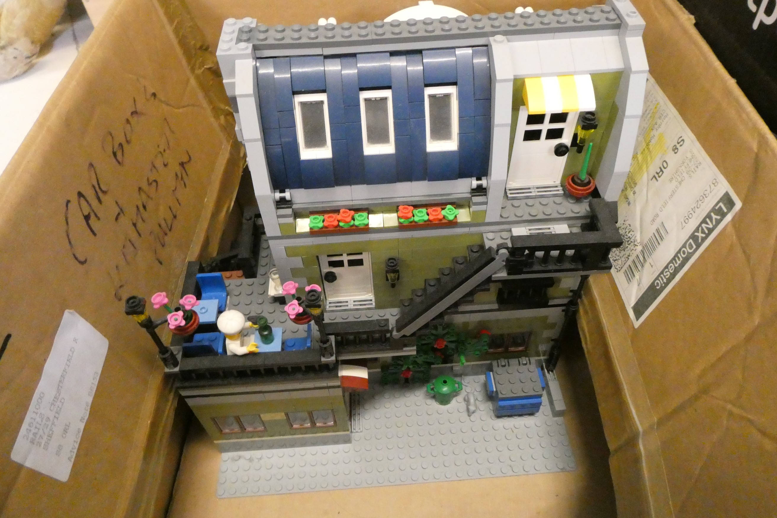 Three boxes of built Lego buildings, unchecked for completeness Image