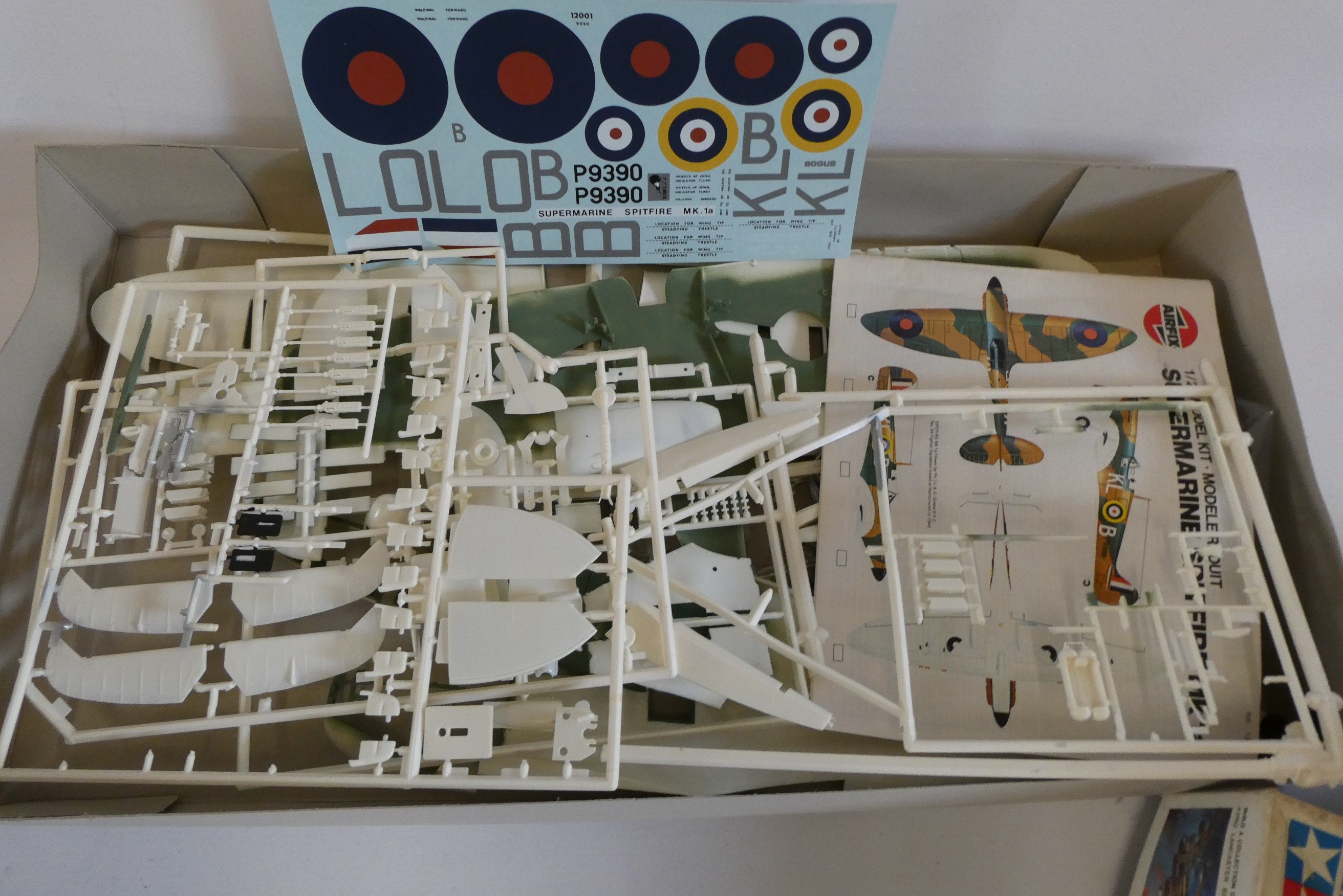 Two plastic aircraft kits comprising Airfix 1/24th scale Spitfire (started) and Tamiya 1/48 scale Image
