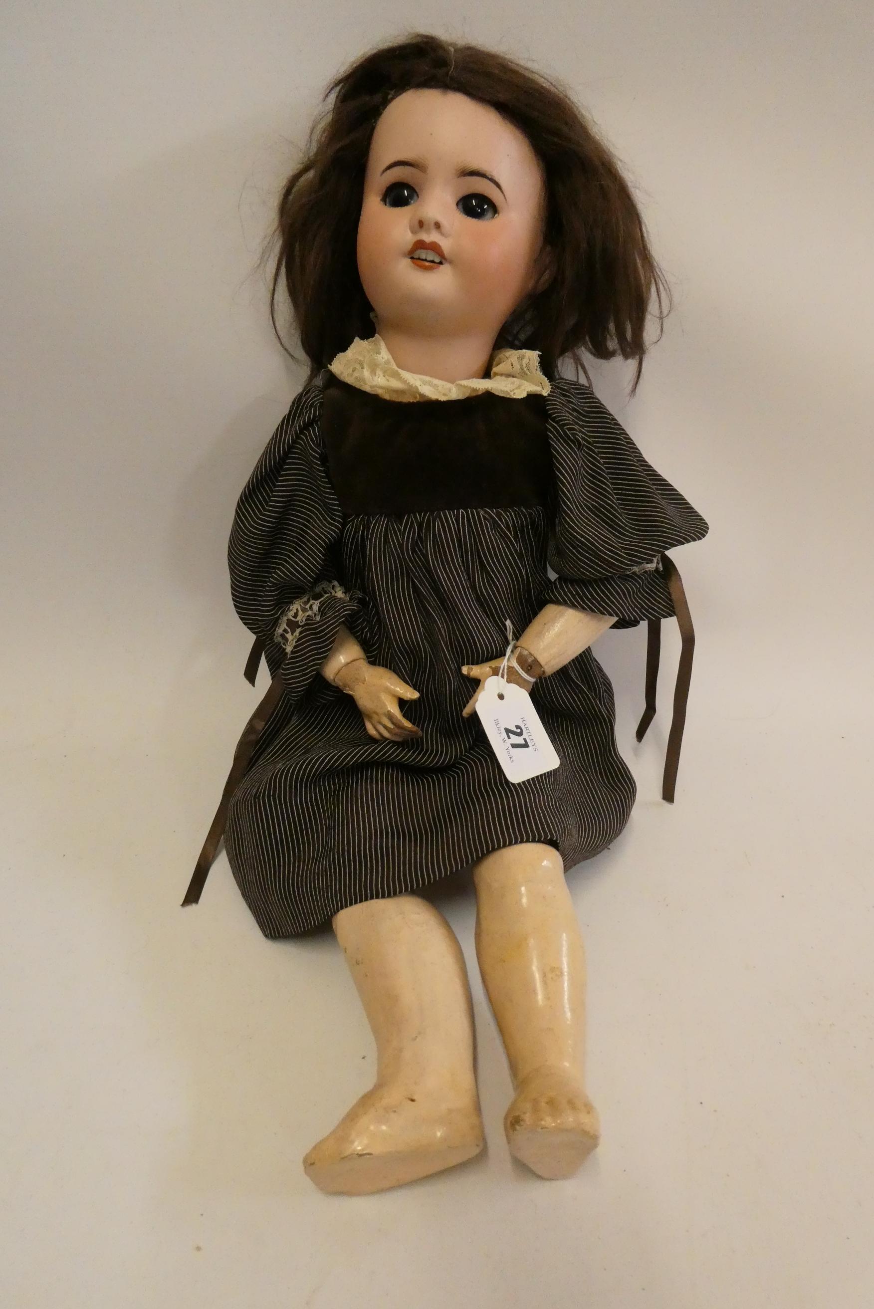 An SFBJ bisque socket head doll, with brown glass sleeping eyes, open mouth, teeth, brown wig, wood Image
