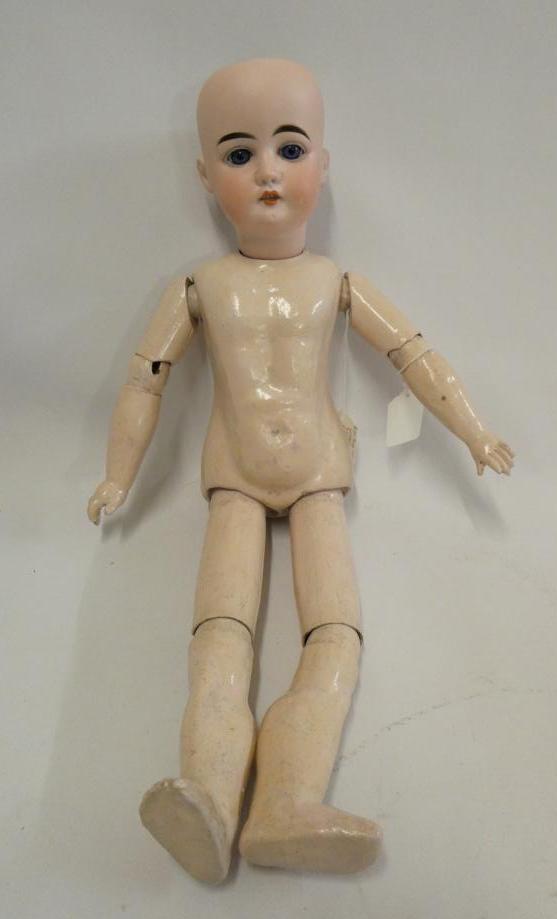 An Arthur Schoenau bisque socket head doll, with blue glass fixed eyes, open mouth, teeth, wood and Image