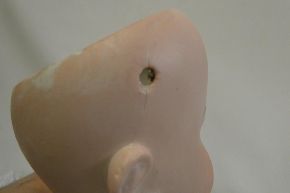 An Arthur Schoenau bisque socket head doll, with blue glass fixed eyes, open mouth, teeth, wood and Image