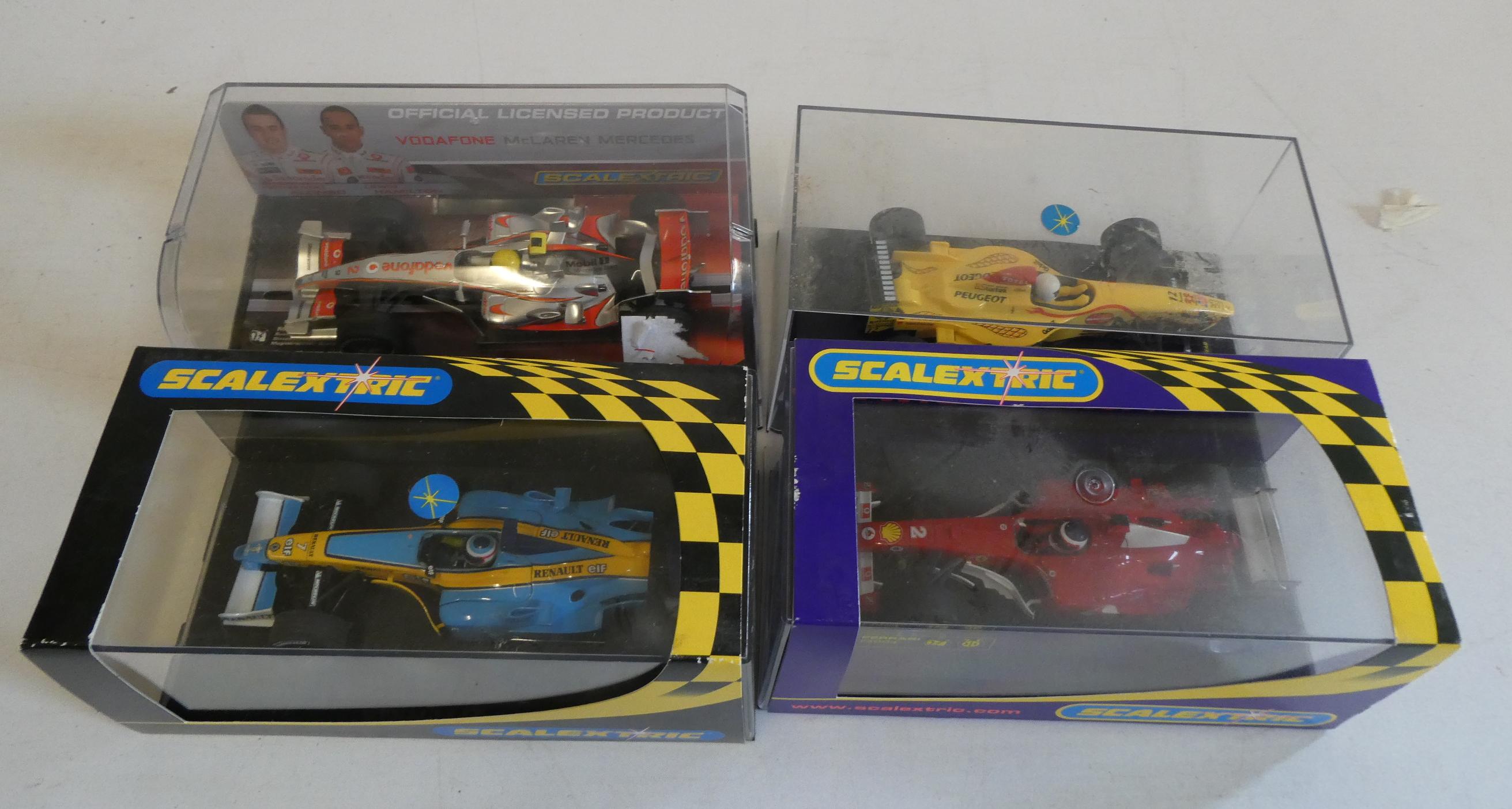 Four Scalextric Formula One race cars including Ferrari, Mclaren and Renault, all items boxed, Image