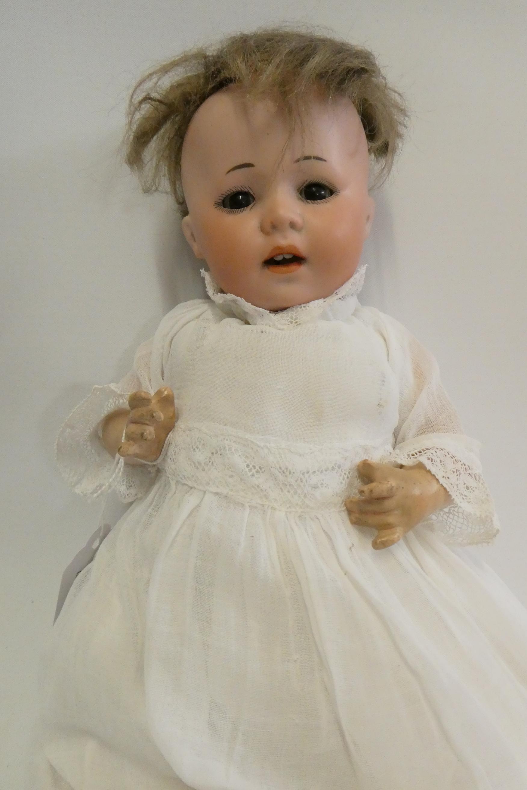 A German bisque socket head doll, with brown glass sleeping eyes, oepn mouth, teeth, bent limb Image
