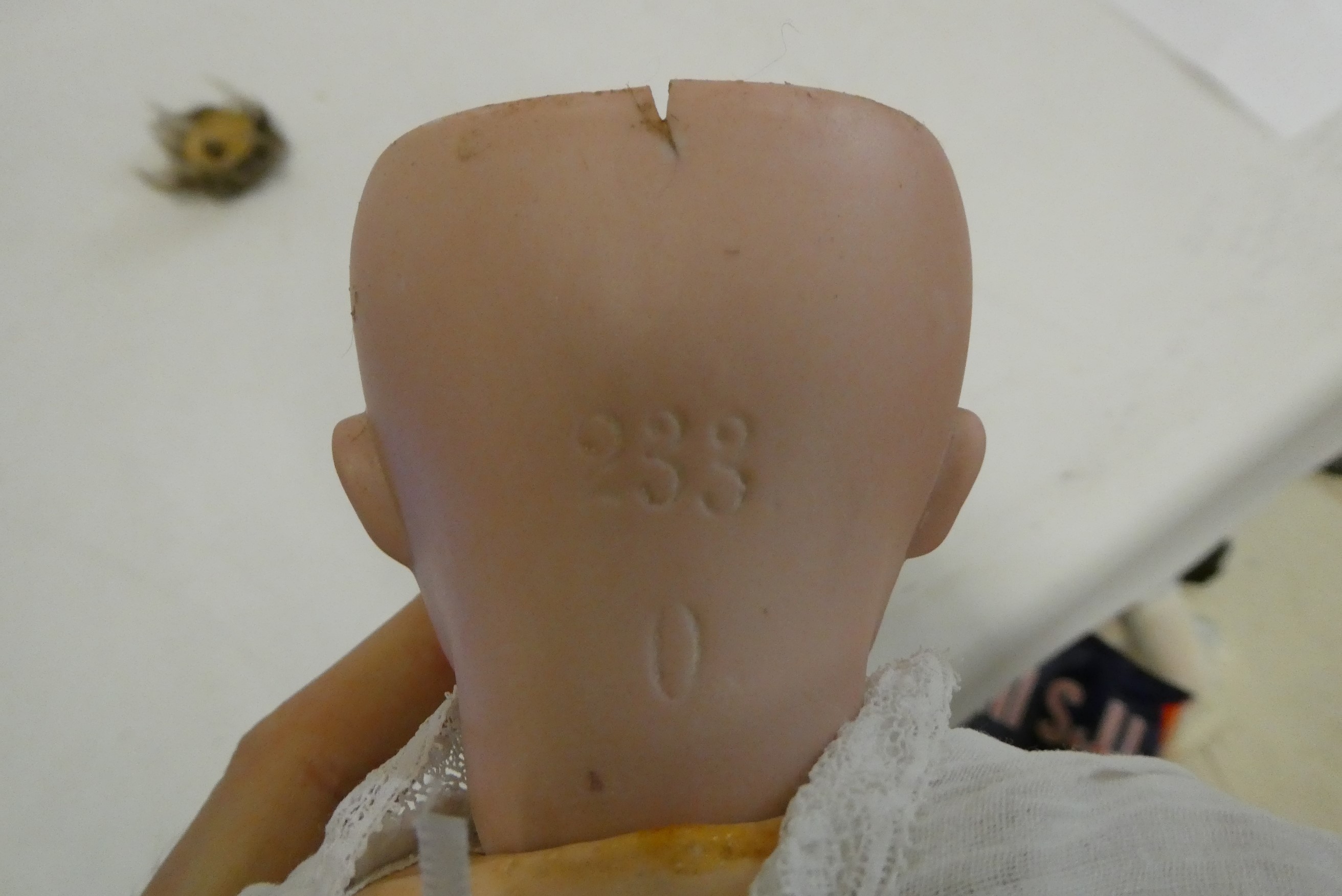 A German bisque socket head doll, with brown glass sleeping eyes, oepn mouth, teeth, bent limb Image