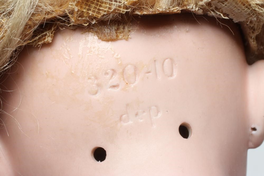 A bisque socket head doll, c.1900, with brown glass sleeping eyes, open mouth, teeth, pierced ears, Image