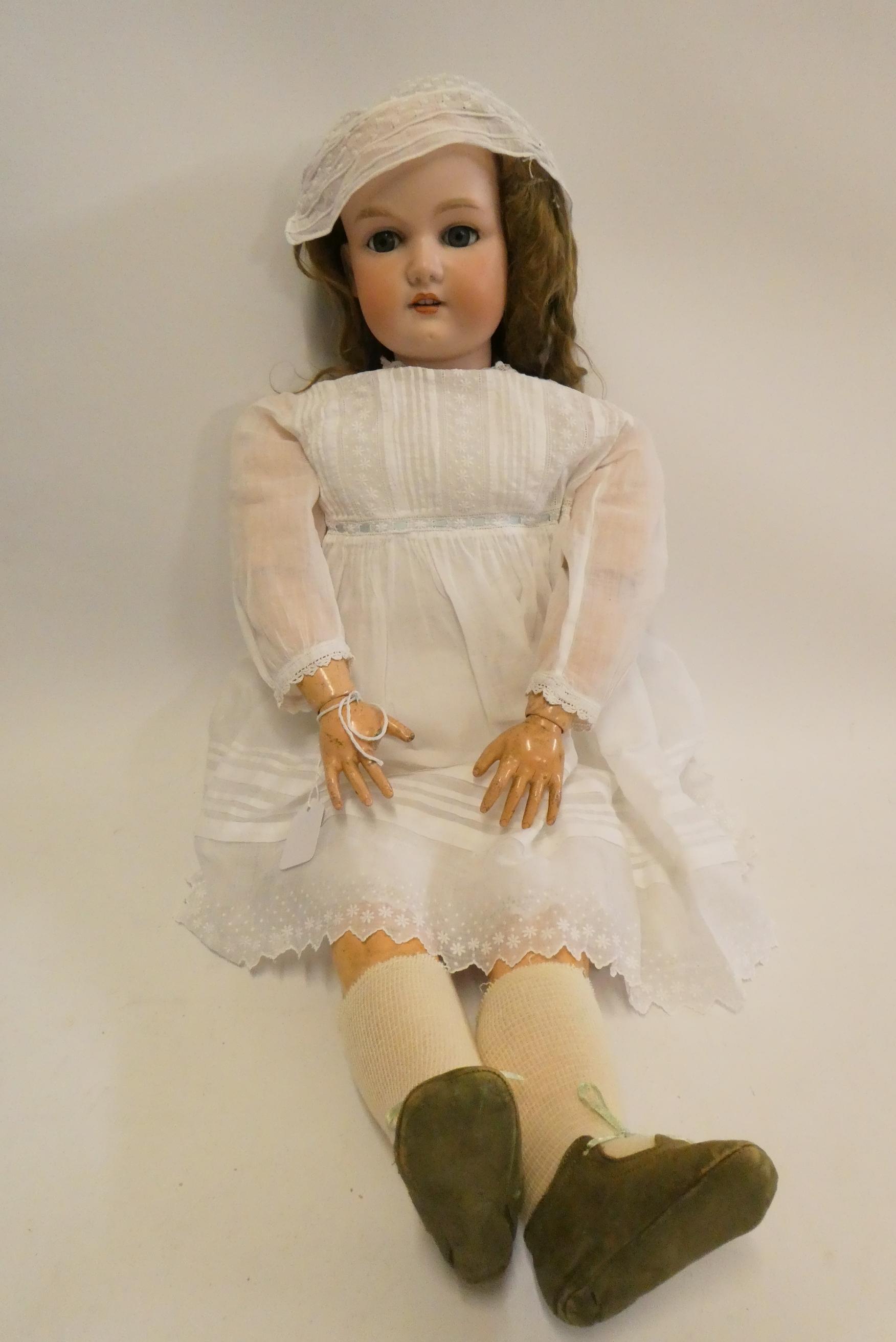 A large Armand Marseille bisque socket head doll, with blue glass sleeping eyes, open mouth, teeth, Image