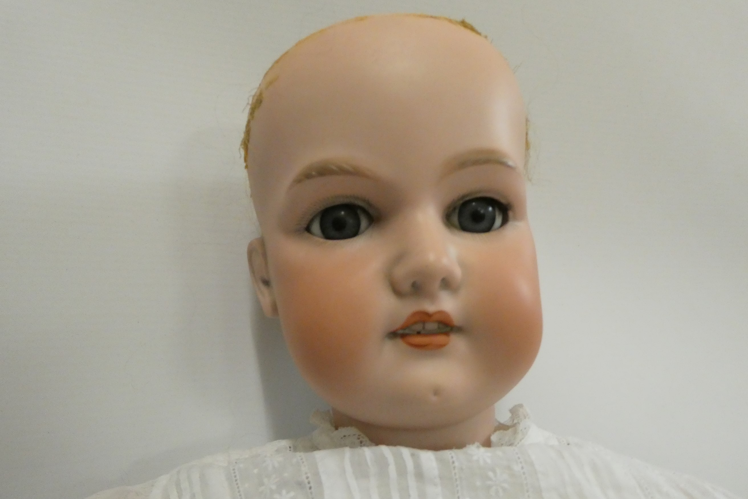 A large Armand Marseille bisque socket head doll, with blue glass sleeping eyes, open mouth, teeth, Image