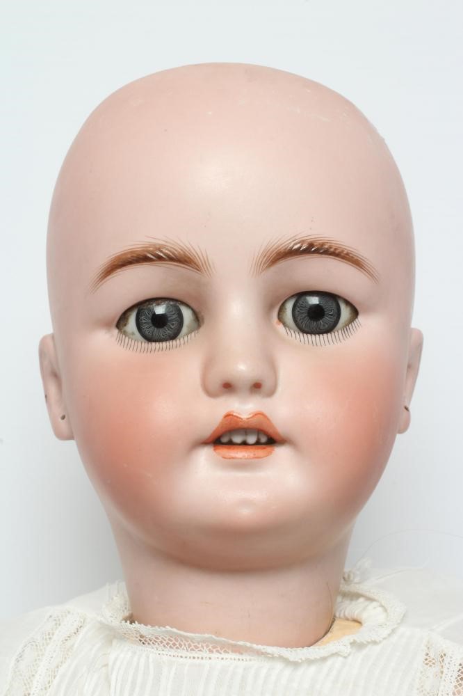 A C.M. Bergmann bisque socket head doll, with blue glass sleeping eyes, open mouth, teeth, pierced Image