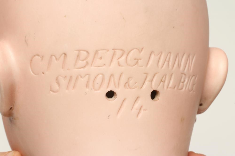 A C.M. Bergmann bisque socket head doll, with blue glass sleeping eyes, open mouth, teeth, pierced Image