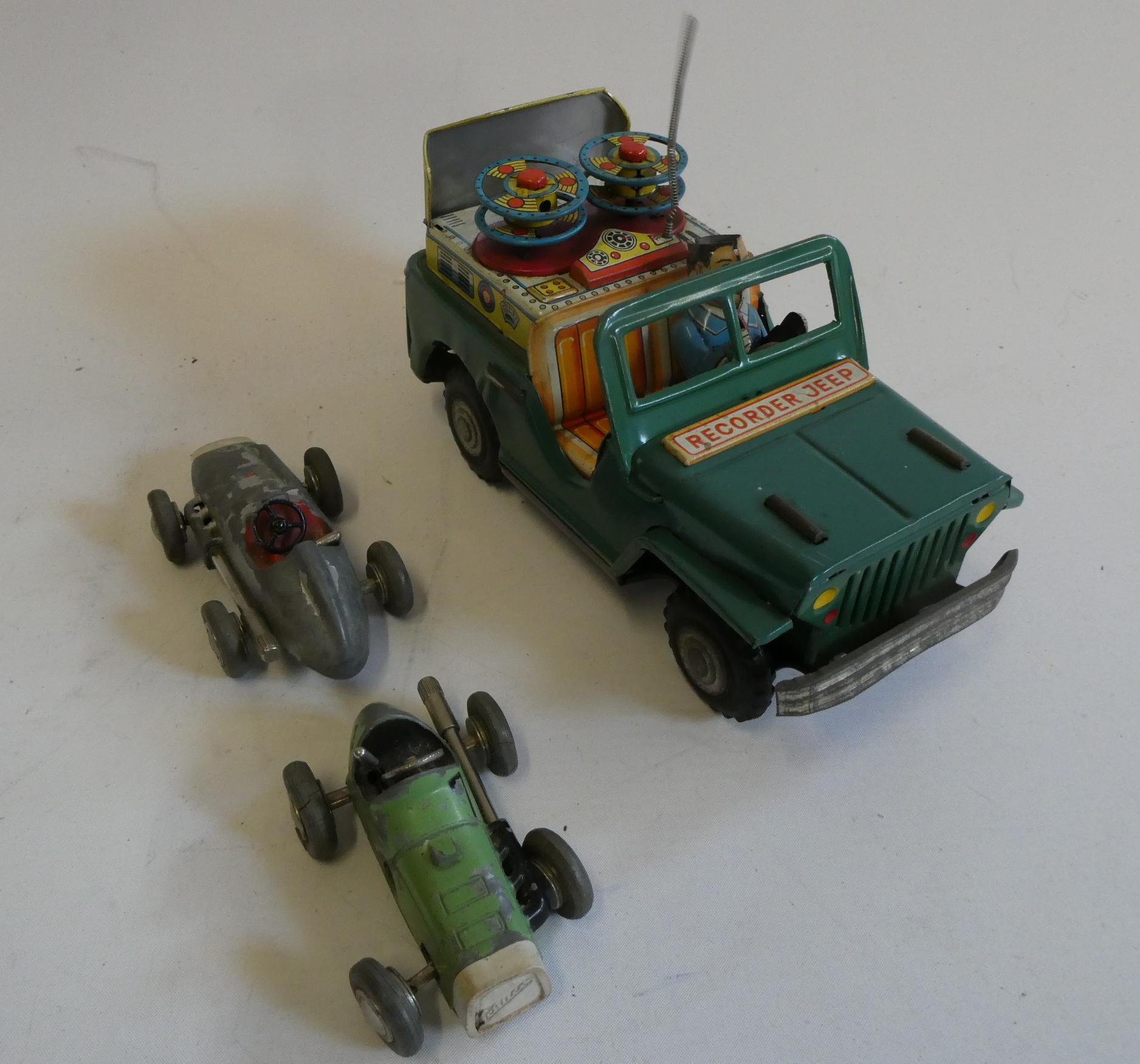 Tinplate friction powered recorder Jeep, drivers hat is missing, and two Schuco Micro Races, paint Image