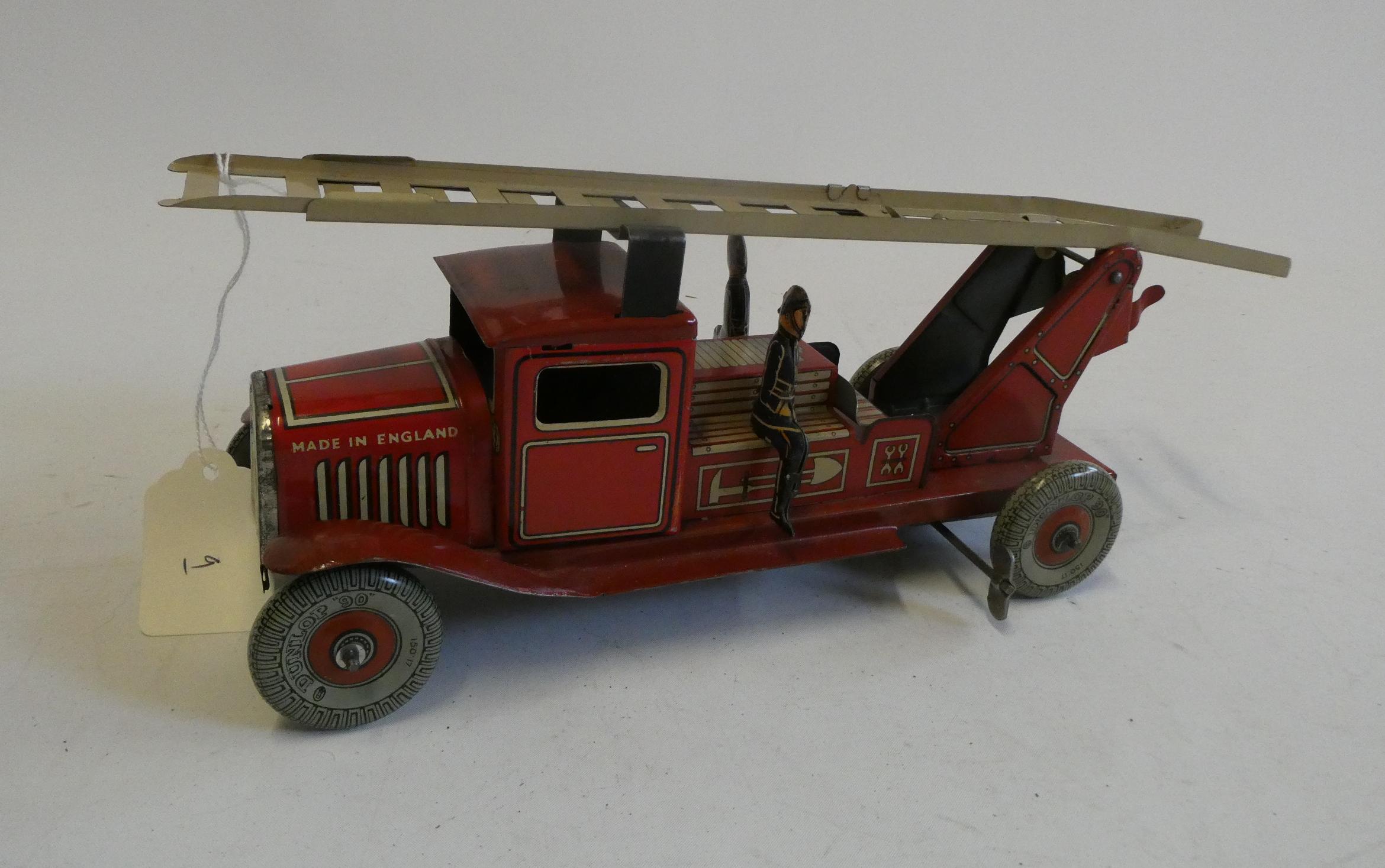 Mettoy clockwork fire engine with escape ladder and three firemen. Overall condition excellent, Image