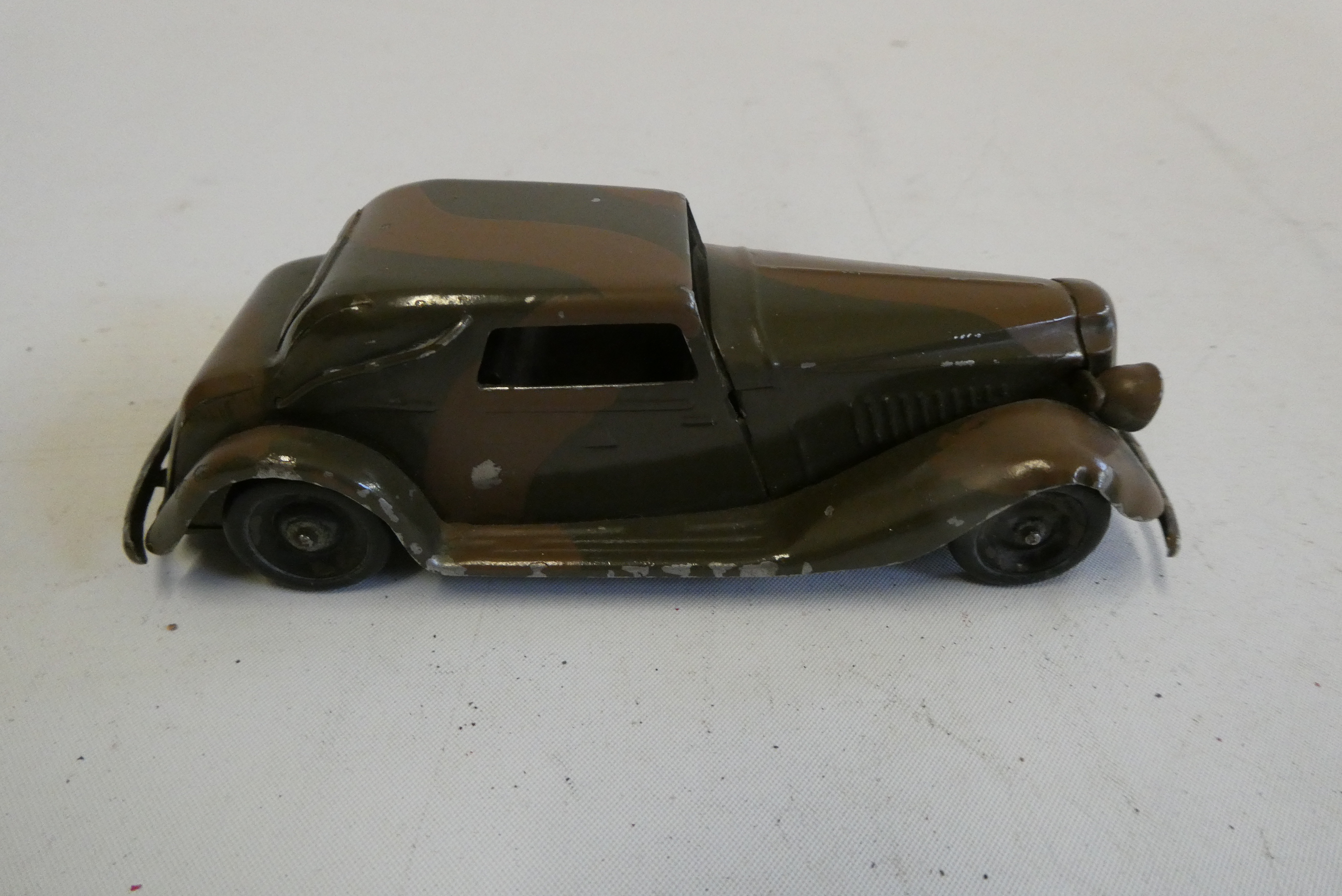 Minic clockwork hand painted camouflage saloon car, one front headlight missing, good Image