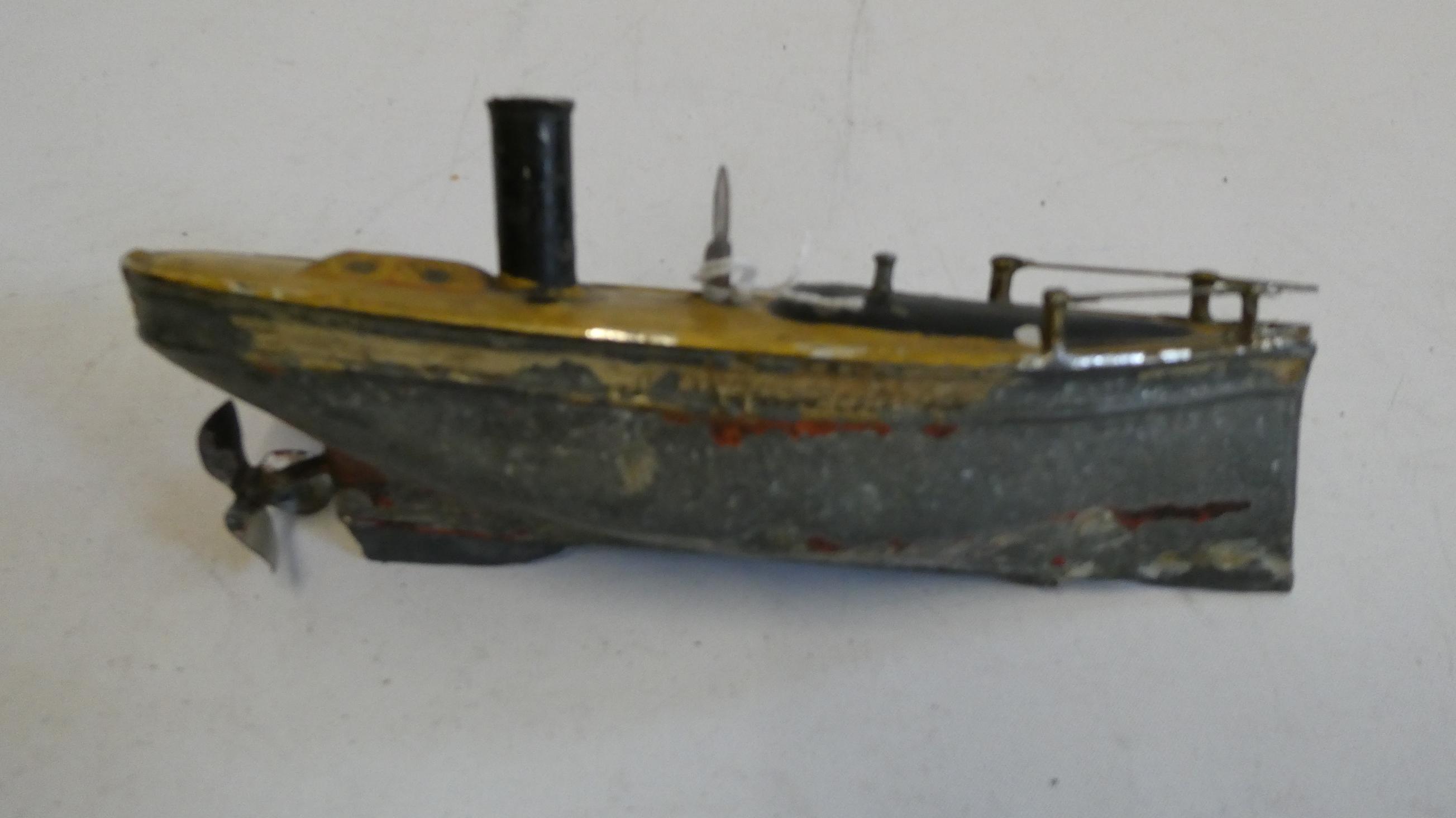Small Carette clockwork steamboat, motor tested working, rudder, flagpole and boat stand missing, Image