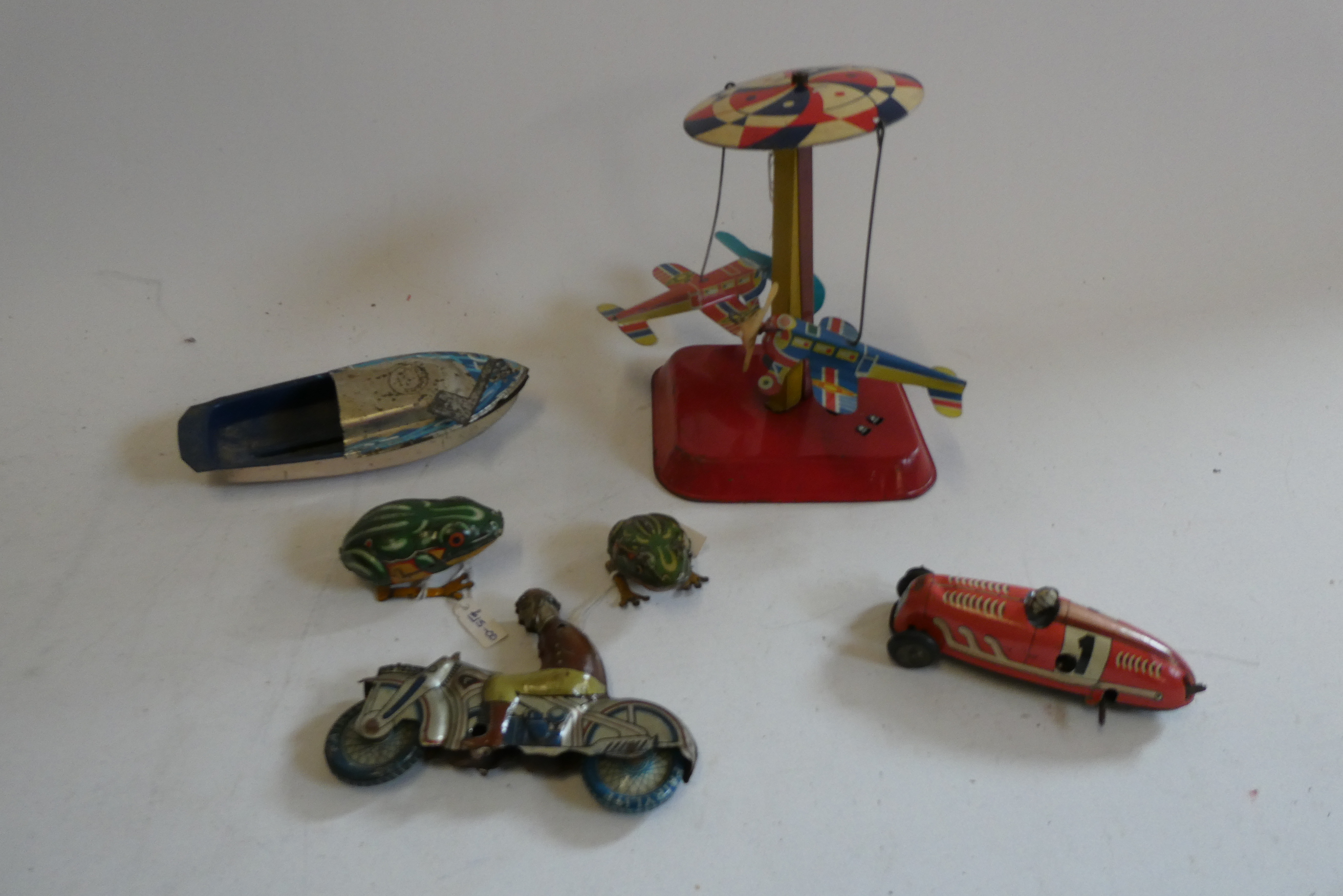 Post war tinplate toys comprising two US zone clockwork frogs, clockwork roundabout, small clockwork Image