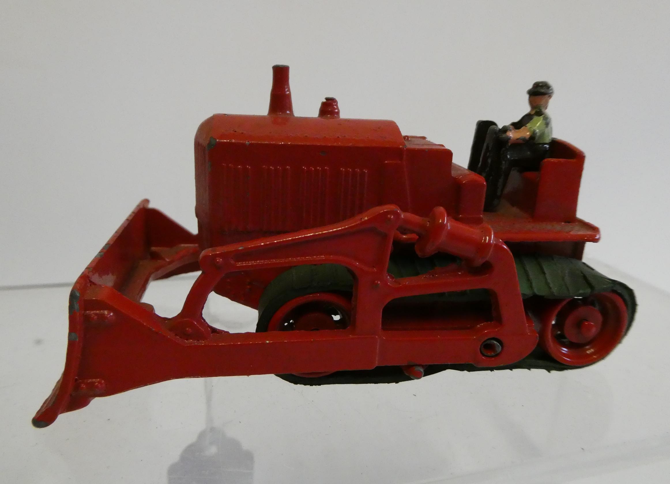 Moko Caterpillar Bulldozer finished in red with driver, rubber tracks fair to good, model good to Image