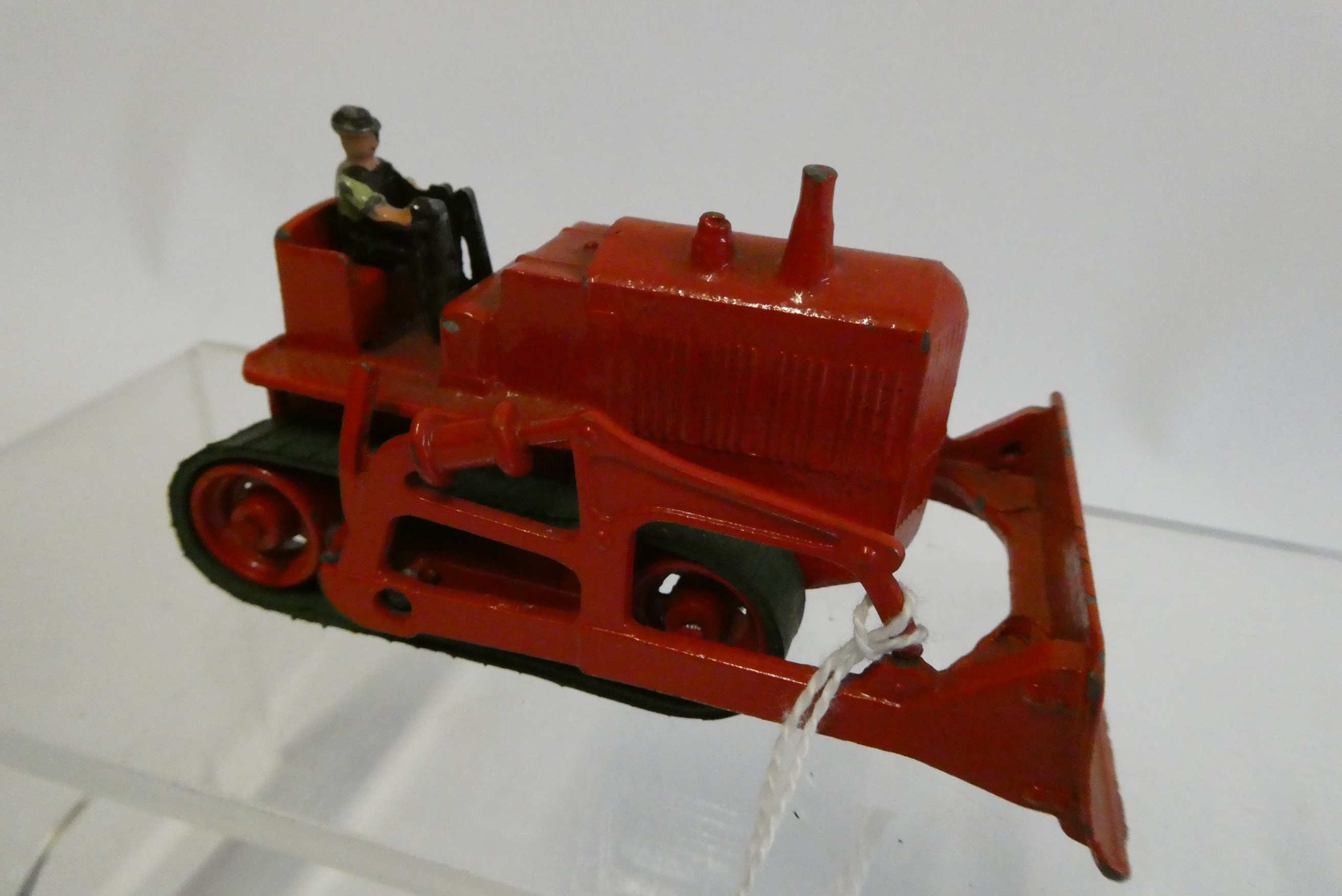 Moko Caterpillar Bulldozer finished in red with driver, rubber tracks fair to good, model good to Image