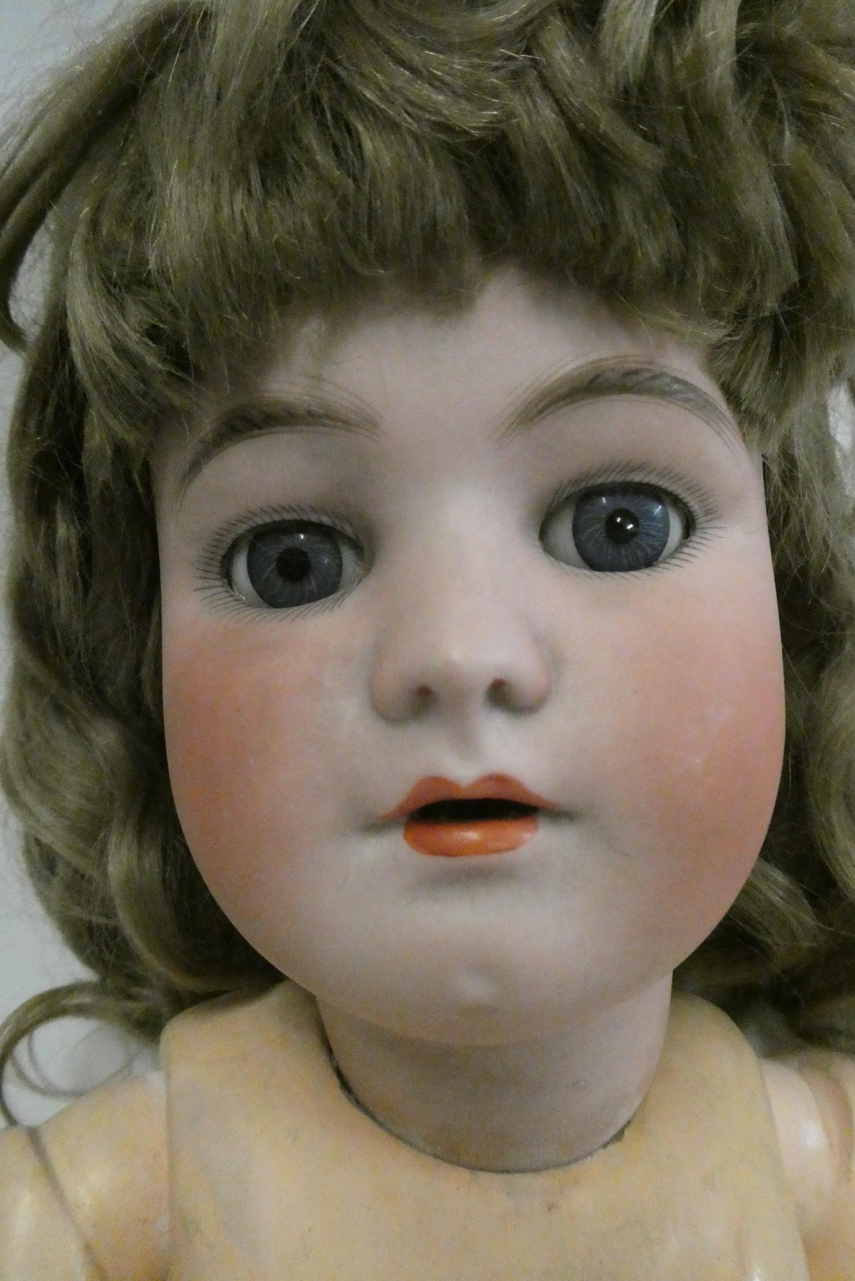 A Heinrich Handwerck Simon & Halbig bisque socket head doll, with blue glass sleeping eyes, open Image