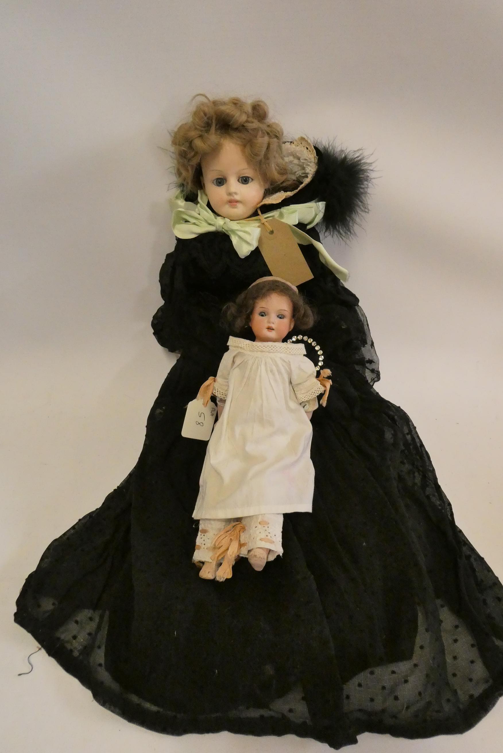 A composition shoulder head doll with fixed blue glass eyes Image