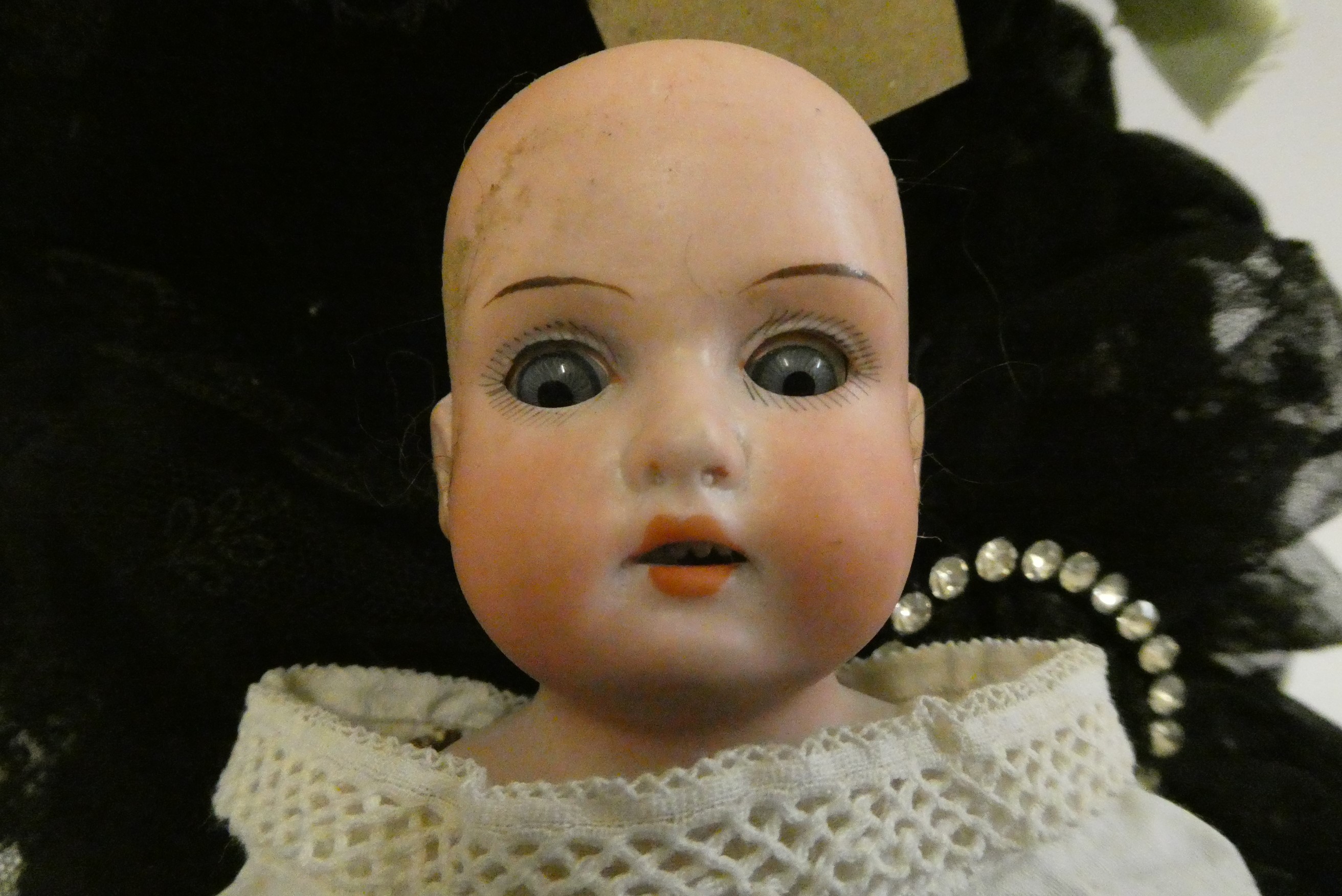 A composition shoulder head doll with fixed blue glass eyes Image