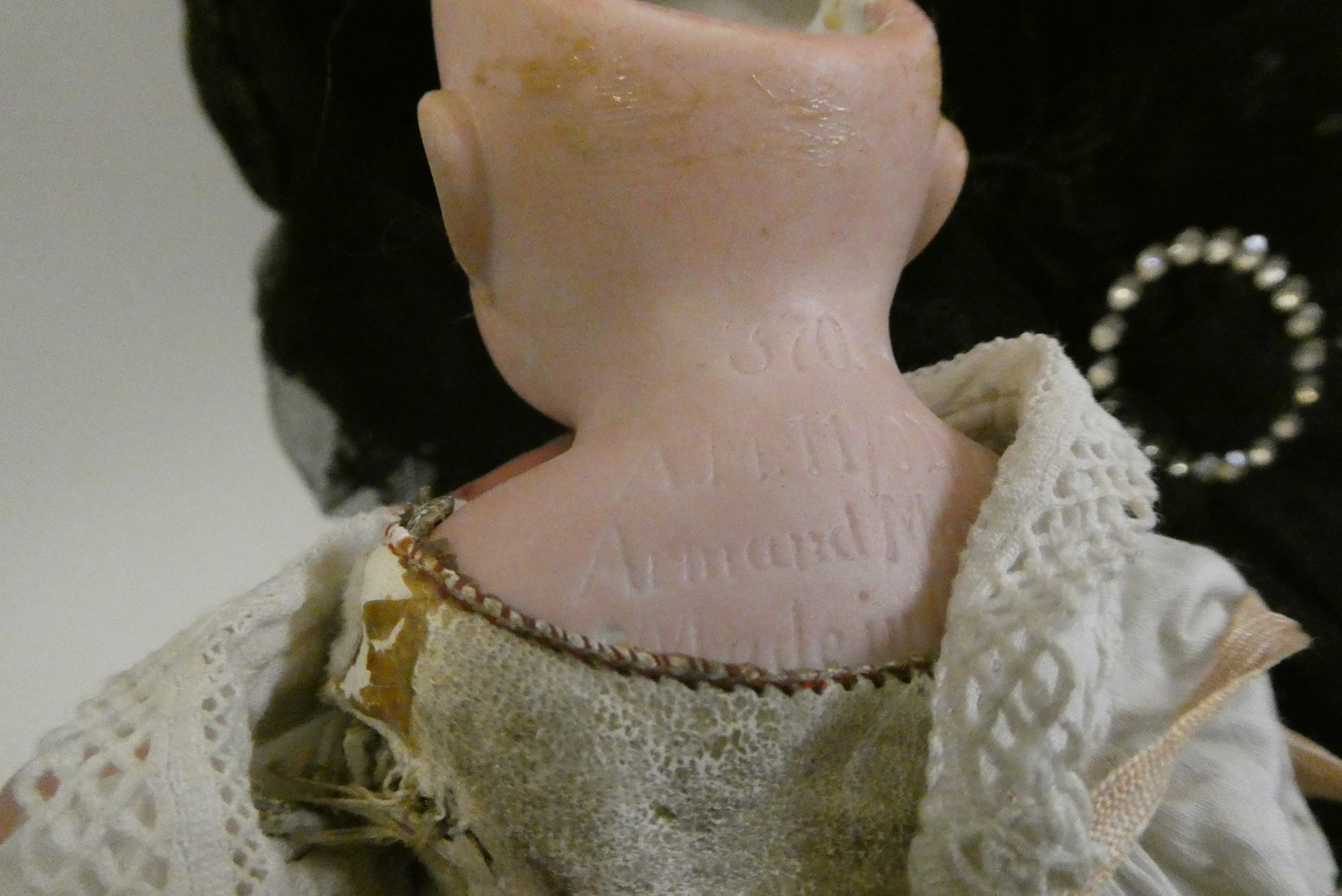 A composition shoulder head doll with fixed blue glass eyes Image