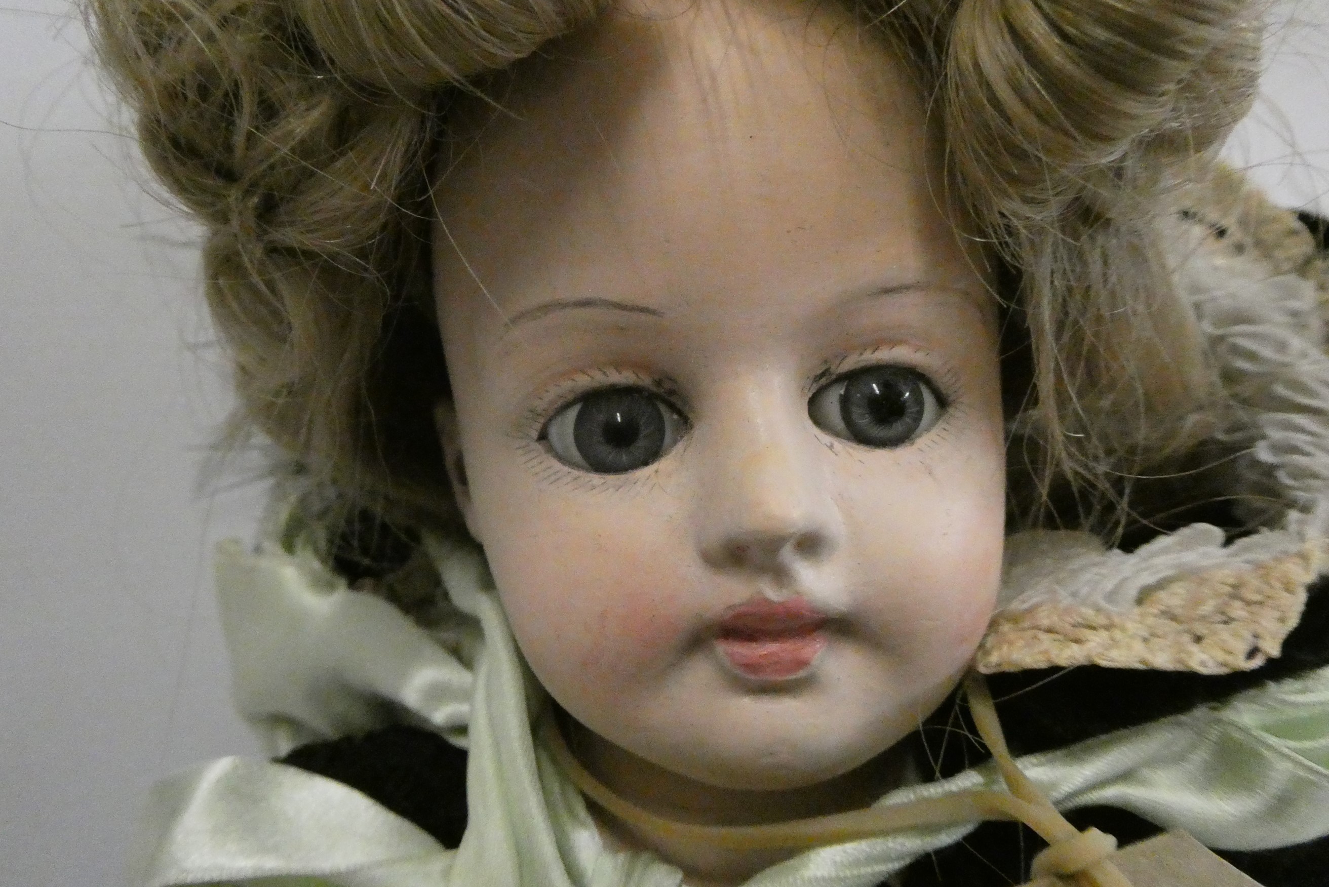 A composition shoulder head doll with fixed blue glass eyes Image