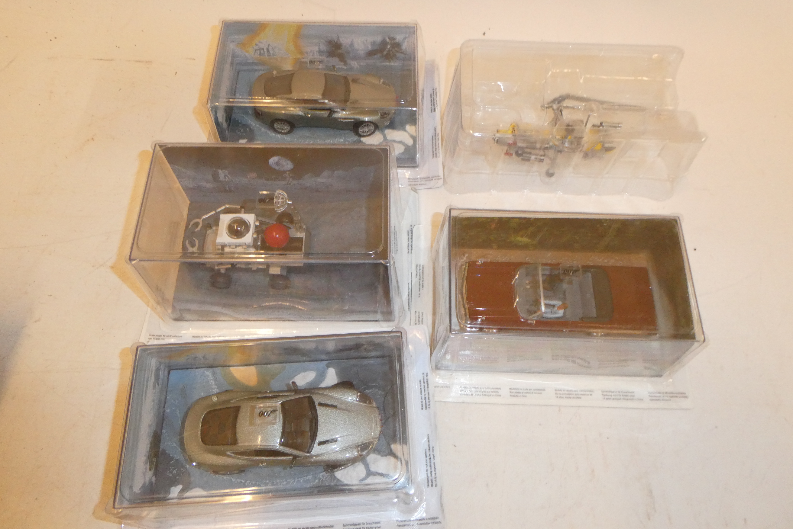 Five Fabbri James Bond vehicles comprising Moon Buggy, two Aston Martins, Vantage Gyrocopter, and Image