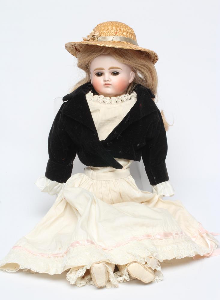 A Belton type bisque shoulder head doll, with brown glass eyes, closed mouth, blond wig, kid body, Image
