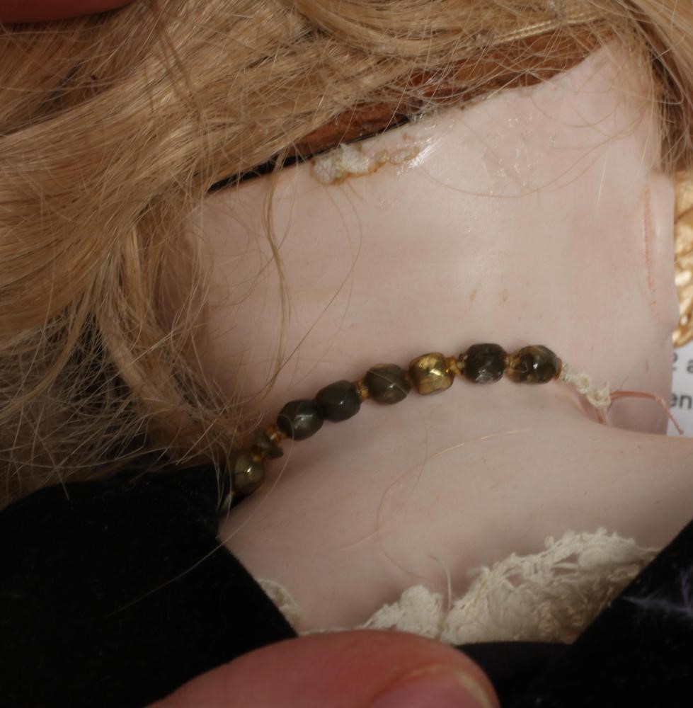 A Belton type bisque shoulder head doll, with brown glass eyes, closed mouth, blond wig, kid body, Image