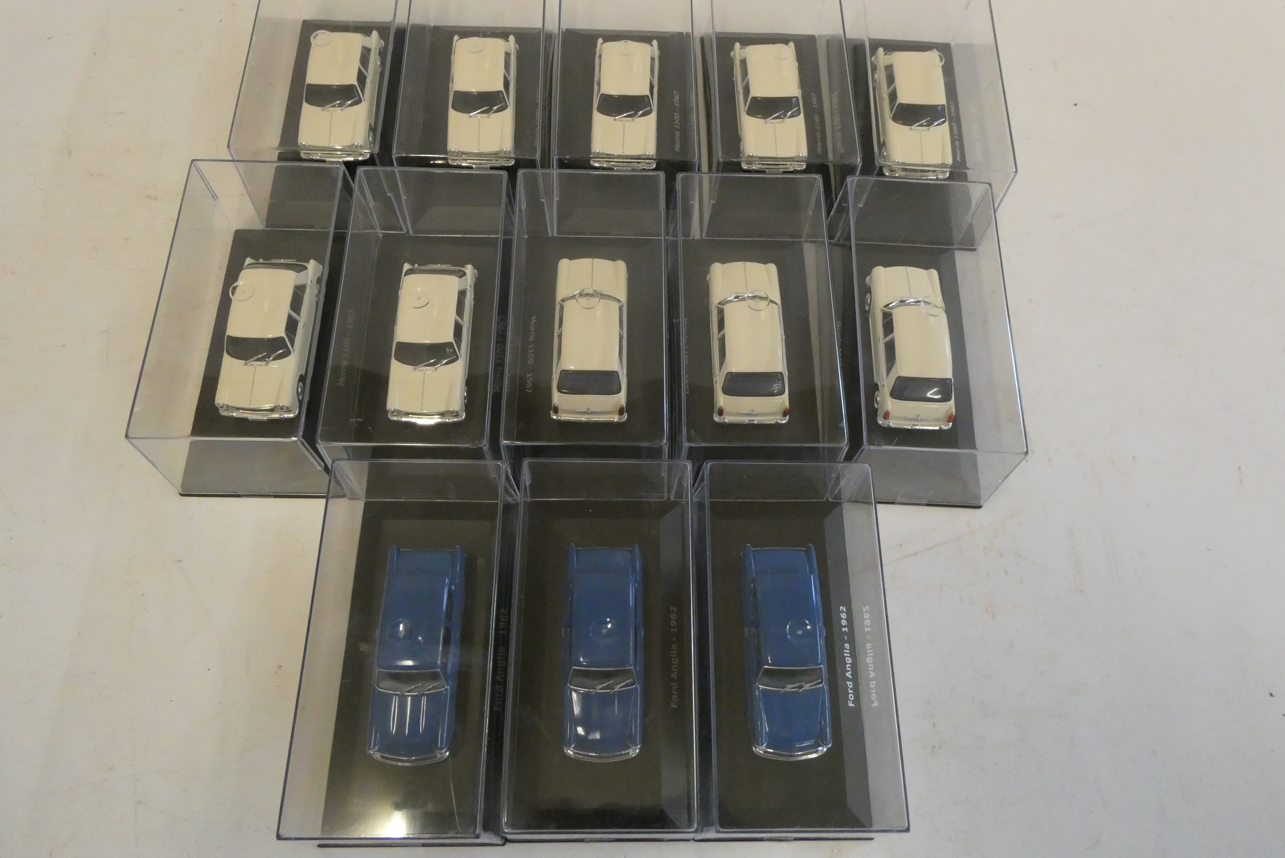 Diecast 1:43 scale cars comprising 10 Morris 110 1967 in white and three blue Ford Anglia, all items Image