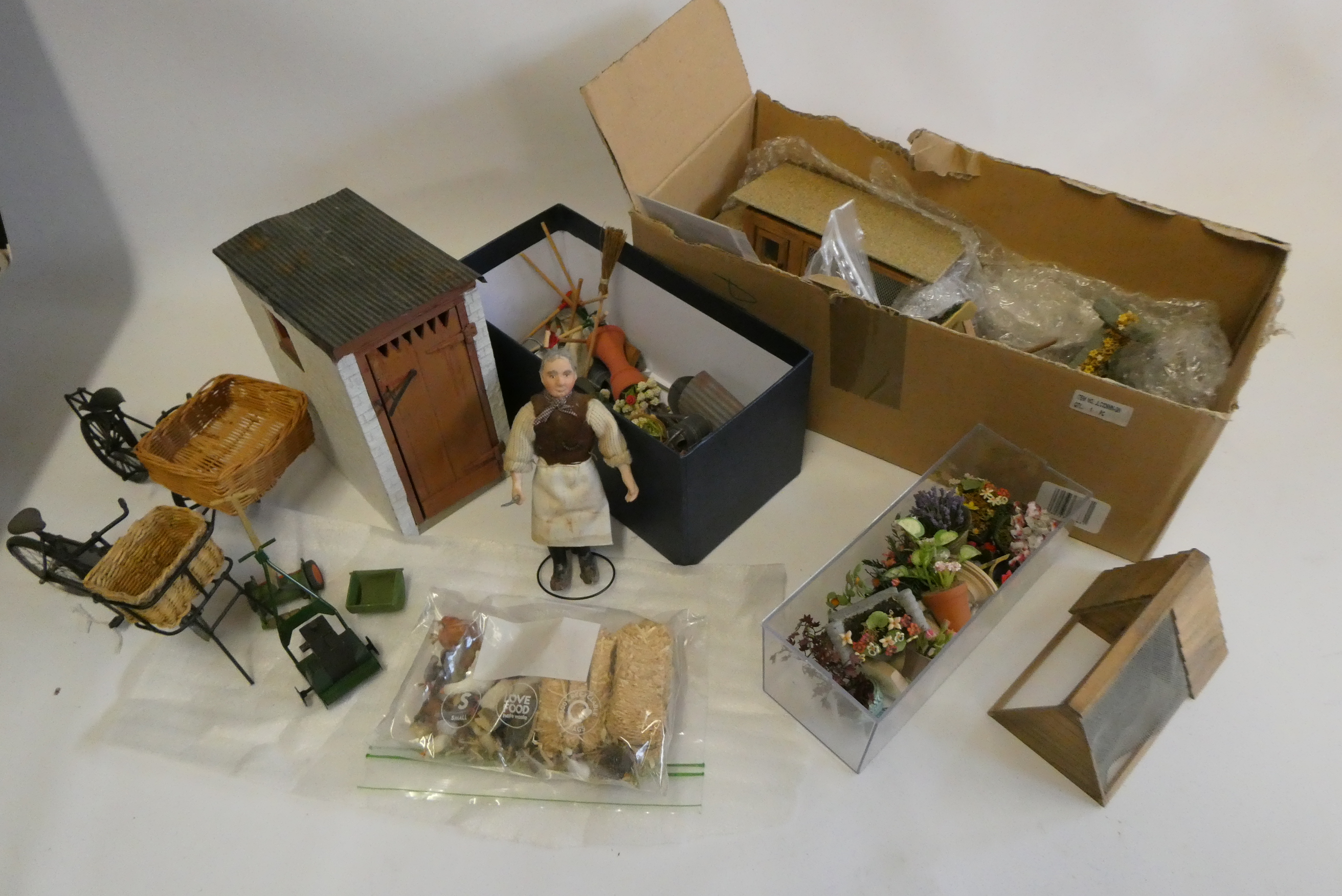 A collection of doll's house garden and outdoor items, including a privy, mowers, croquet set, faux Image