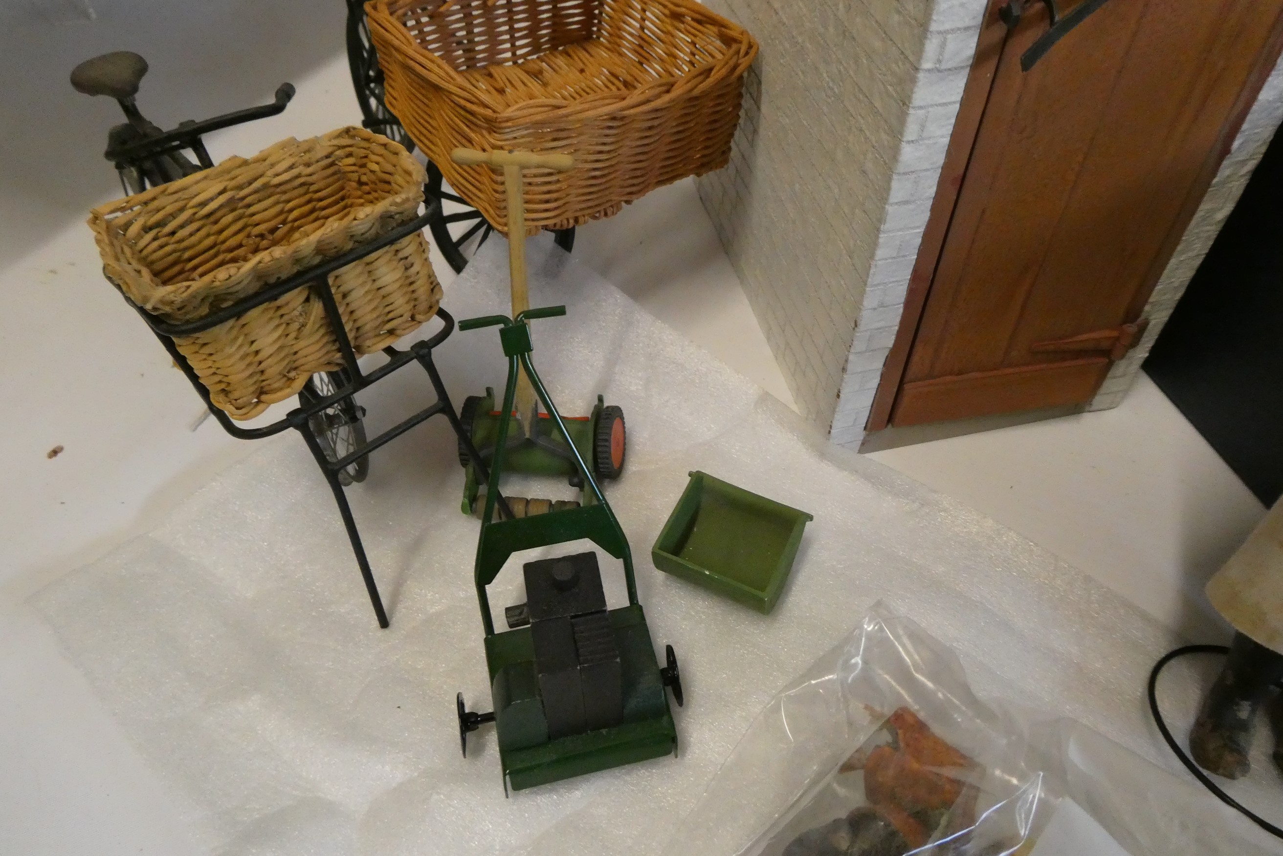 A collection of doll's house garden and outdoor items, including a privy, mowers, croquet set, faux Image