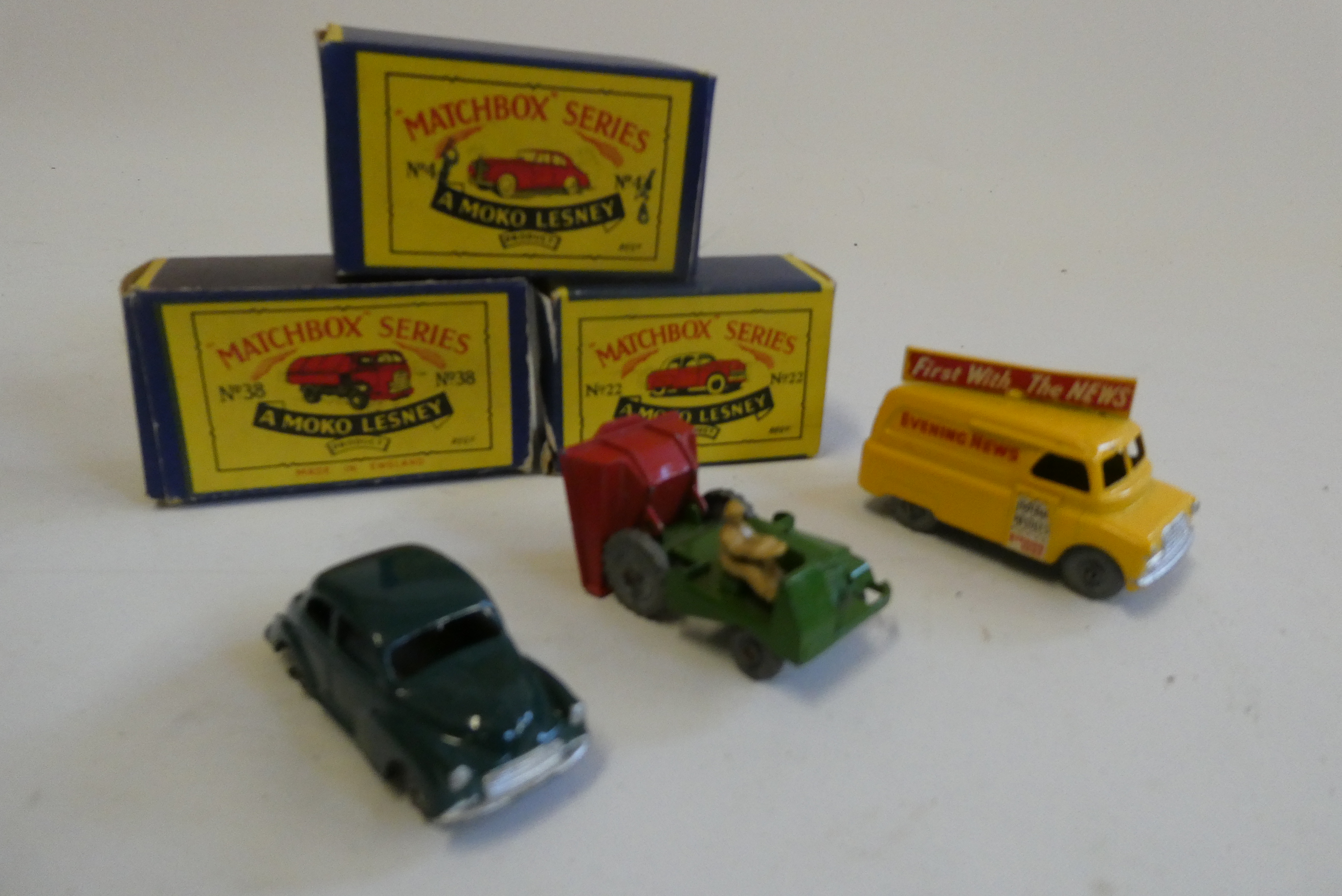 Three unboxed Matchbox vehicles comprising Yellow Bedford News van, dark green Morris Minor and Site Image