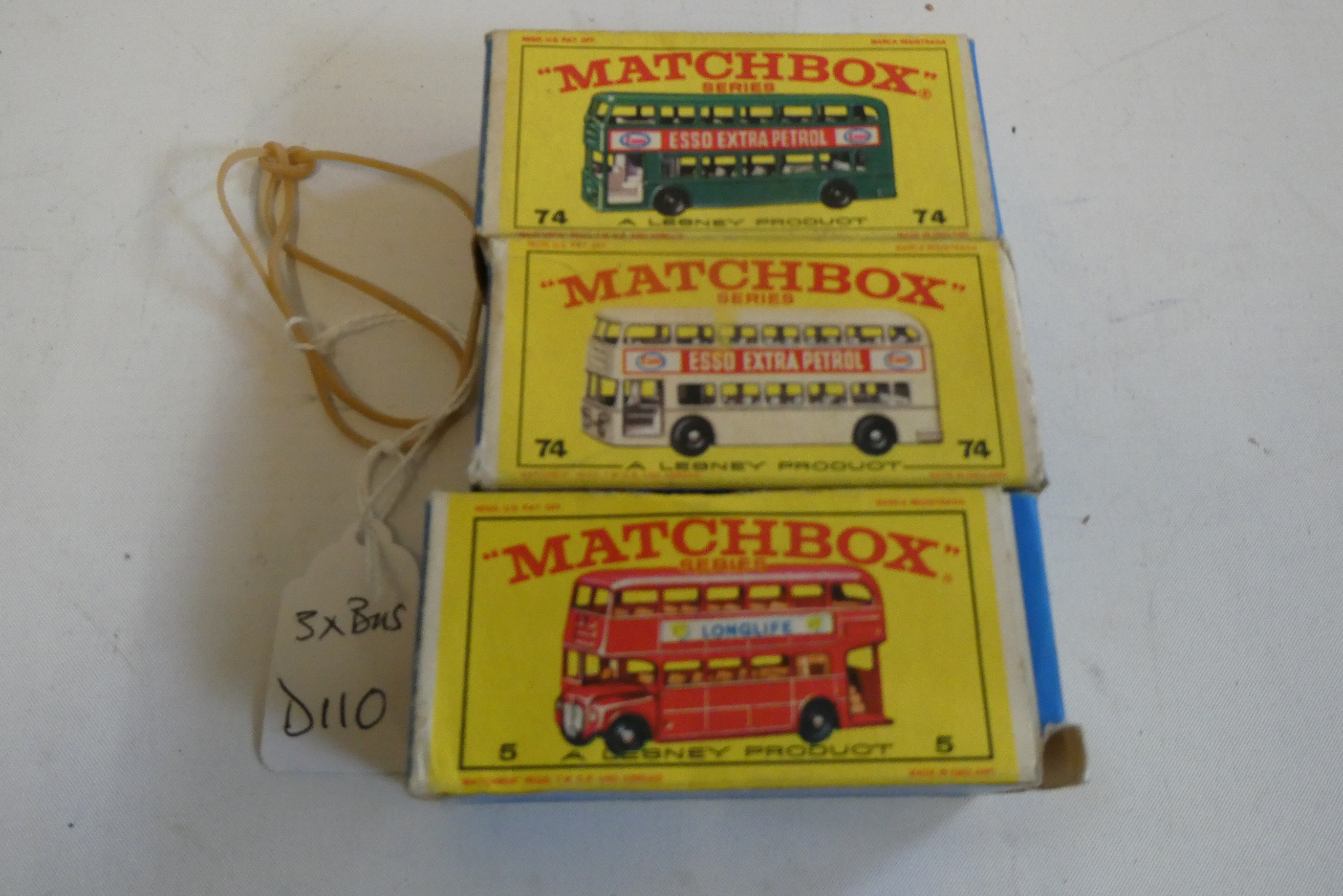 Three Matchbox bus models comprising No.74 Daimler in green, Esso Extra petrol, No.74 Daimler in Image