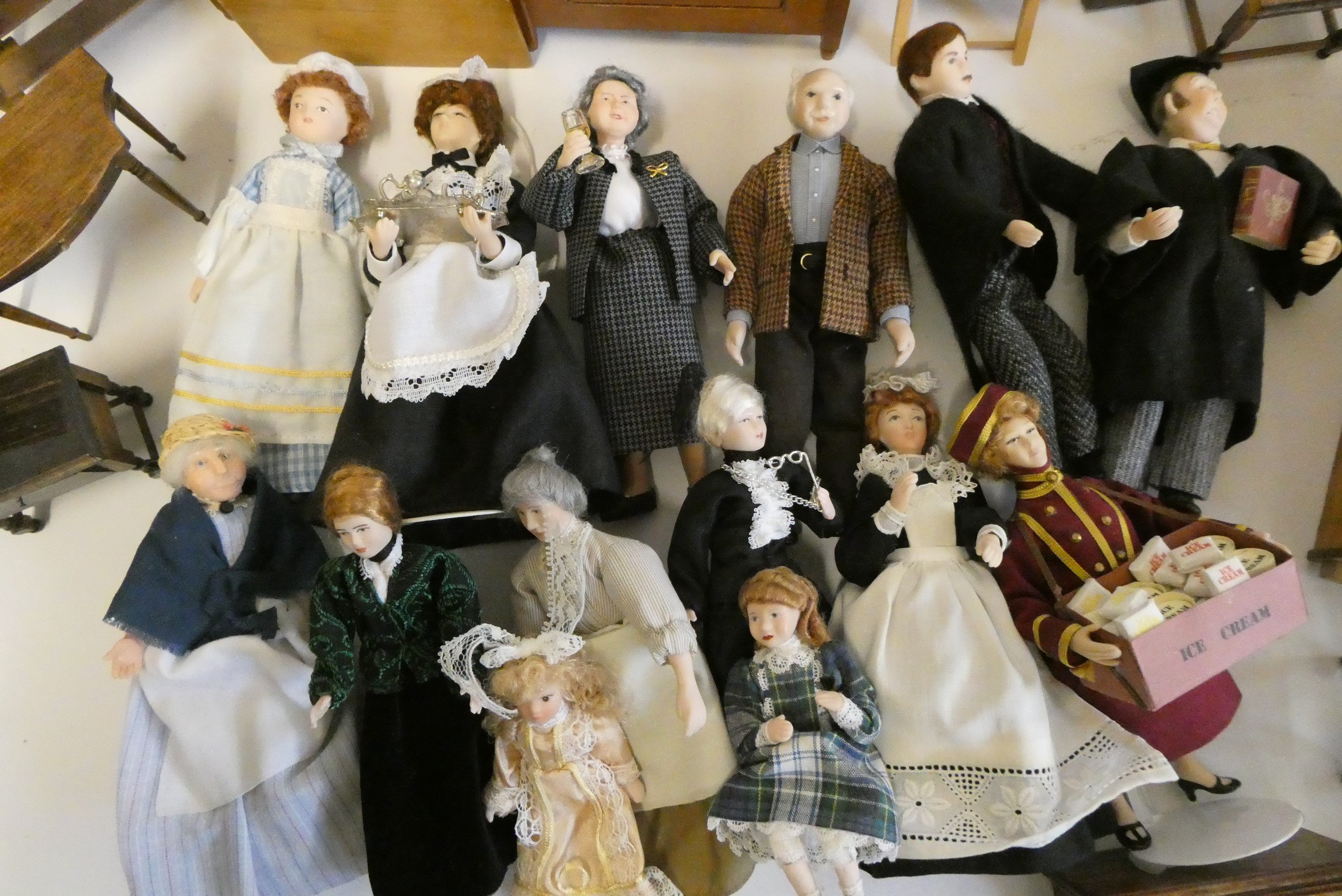 A collection of doll's house furniture and dolls, including wardrobes, dining tables chairs, chests Image