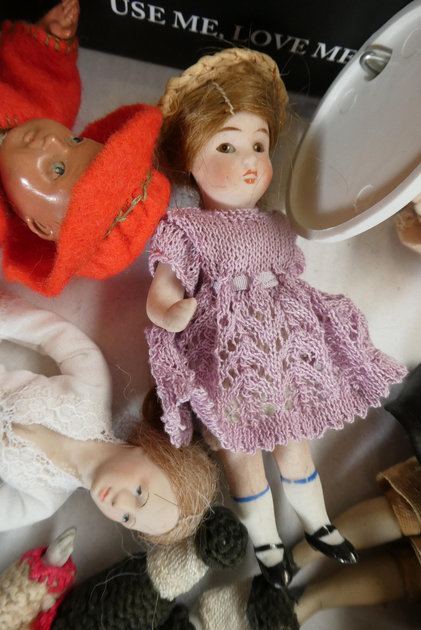 A small collection of dolls house dolls including antique bisque examples, Victorian china busts and Image