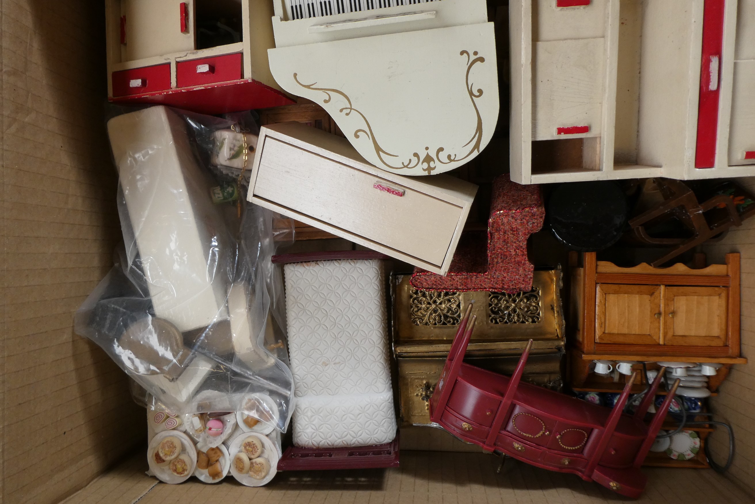 Two boxes of dolls house furniture and accessories, including wood, metal and textile items Image