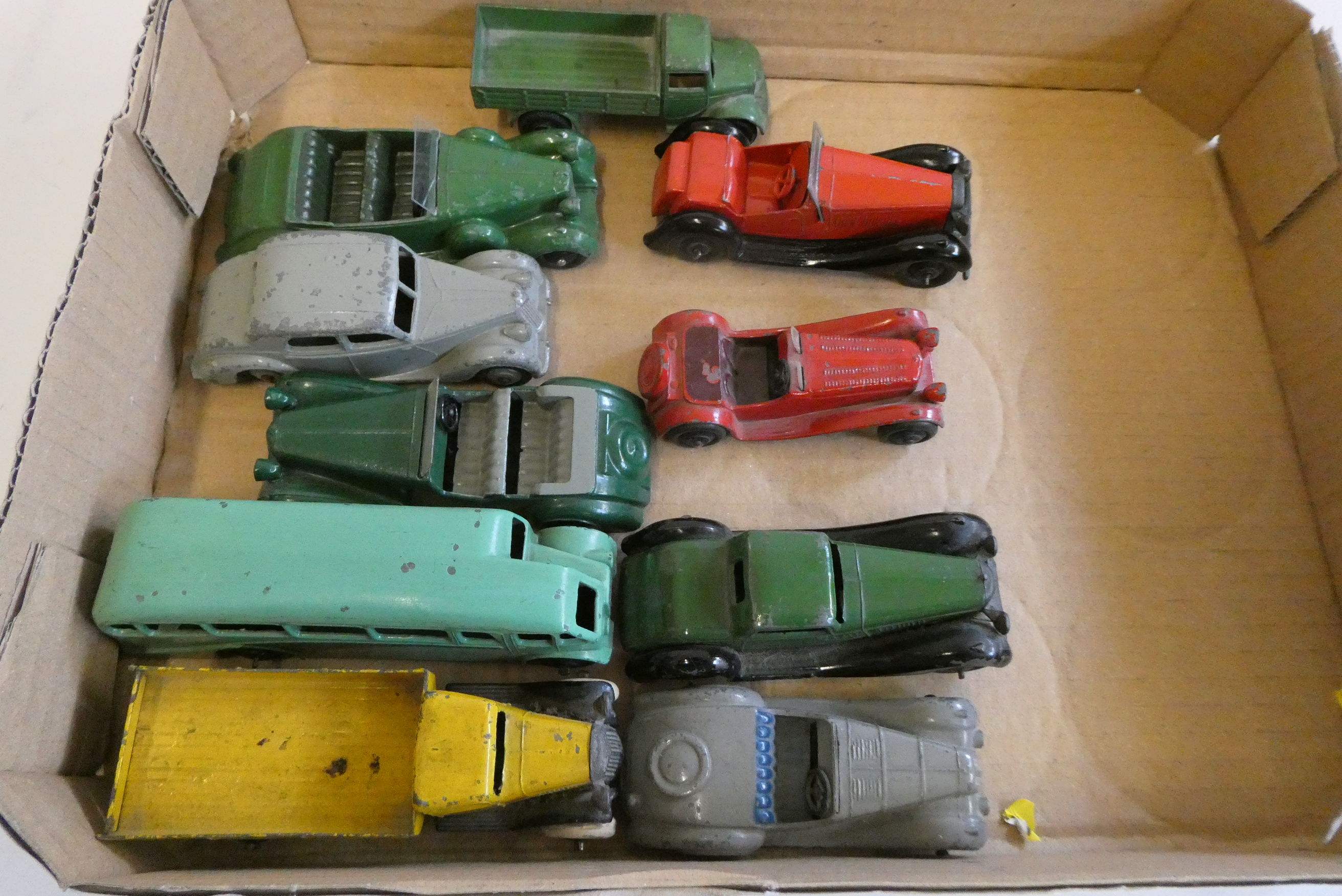 Ten unboxed early Dinky vehicles including saloon cars, bus and trucks items, in fair condition Image