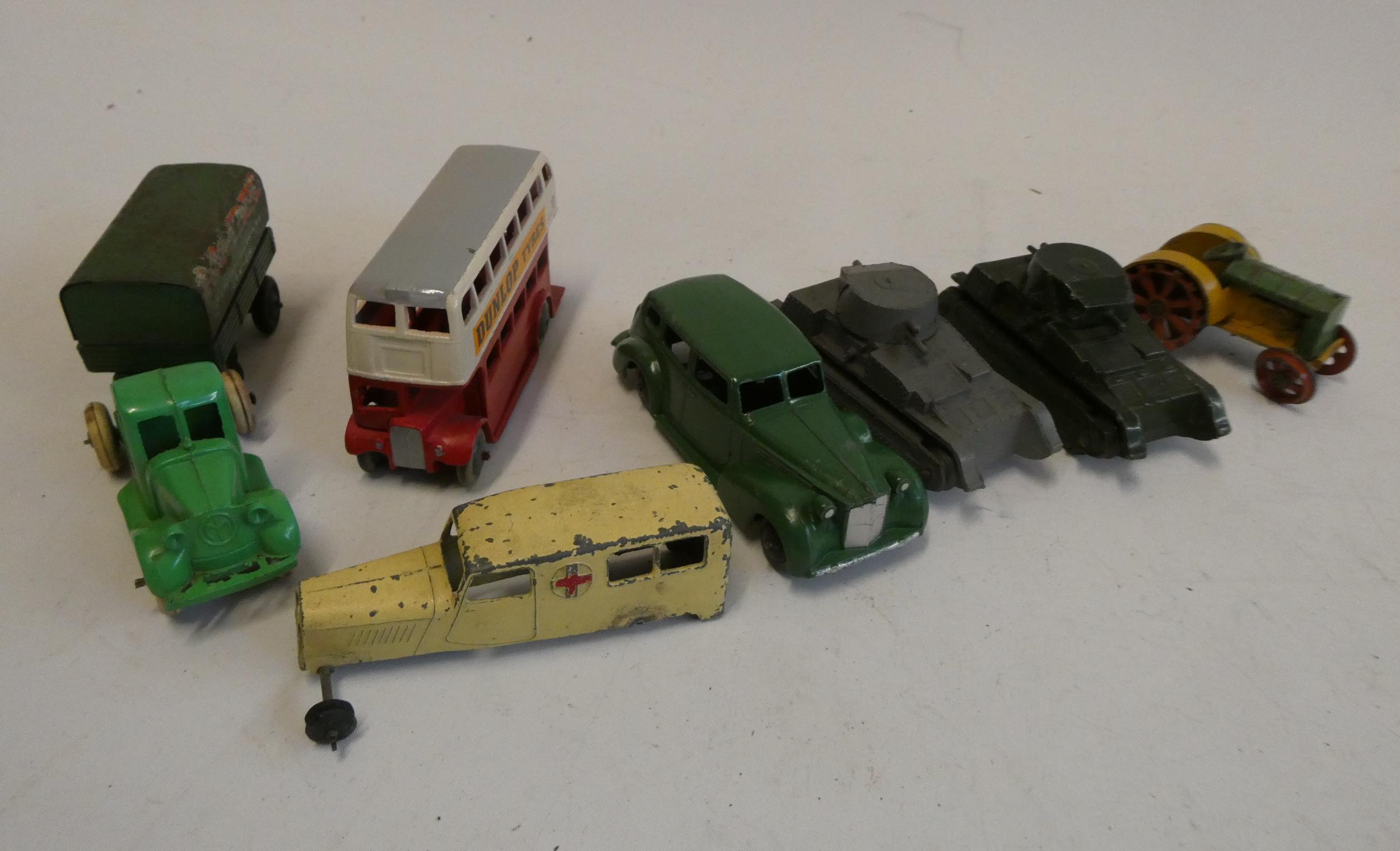 Pre-war Dinky tractor finished in green and yellow, two pre-war tanks, and three further Dinky Image